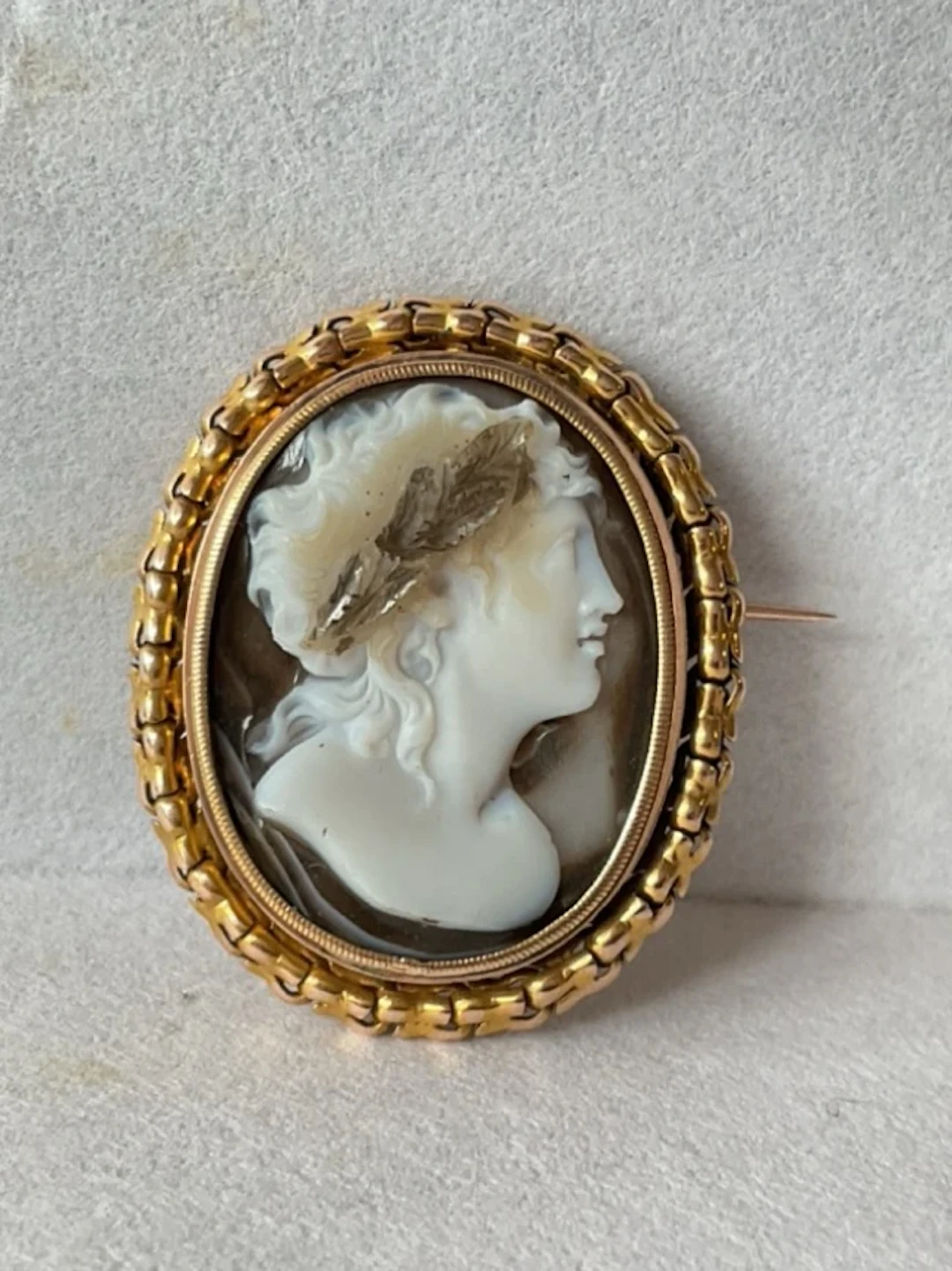 An antique banded agate hardstone cameo brooch of a classical lady