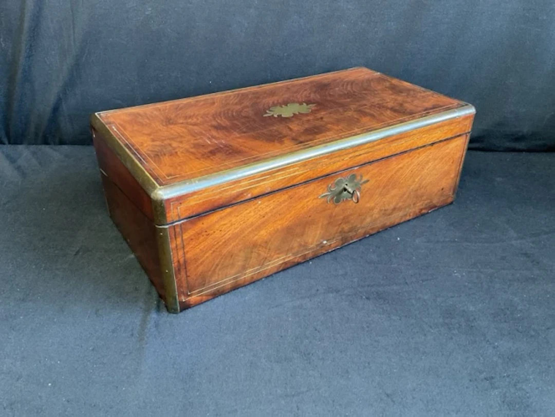 A nineteenth century mahogany brass bound writing box inlaid with
