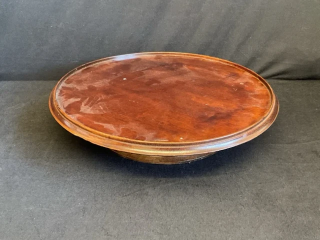 A Victorian style circular mahogany lazy susan with raised moulded