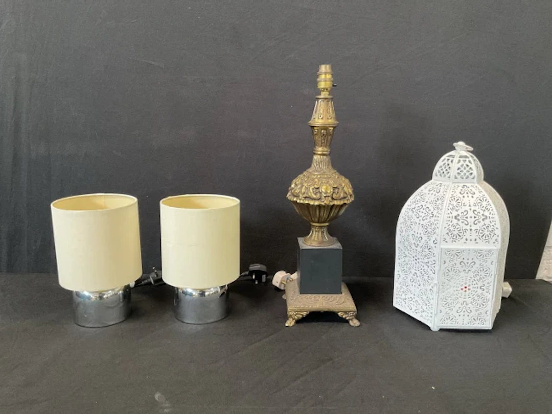 A pair of modern chrome tablelamps with cylindrical shades; a baroque