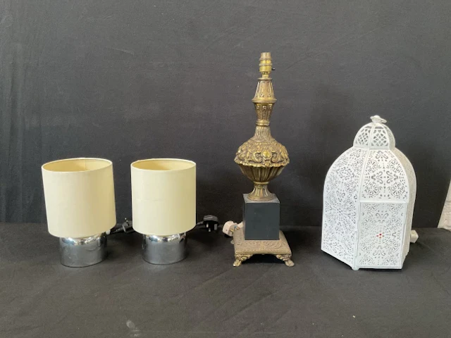 A pair of modern chrome tablelamps with cylindrical shades; a baroque