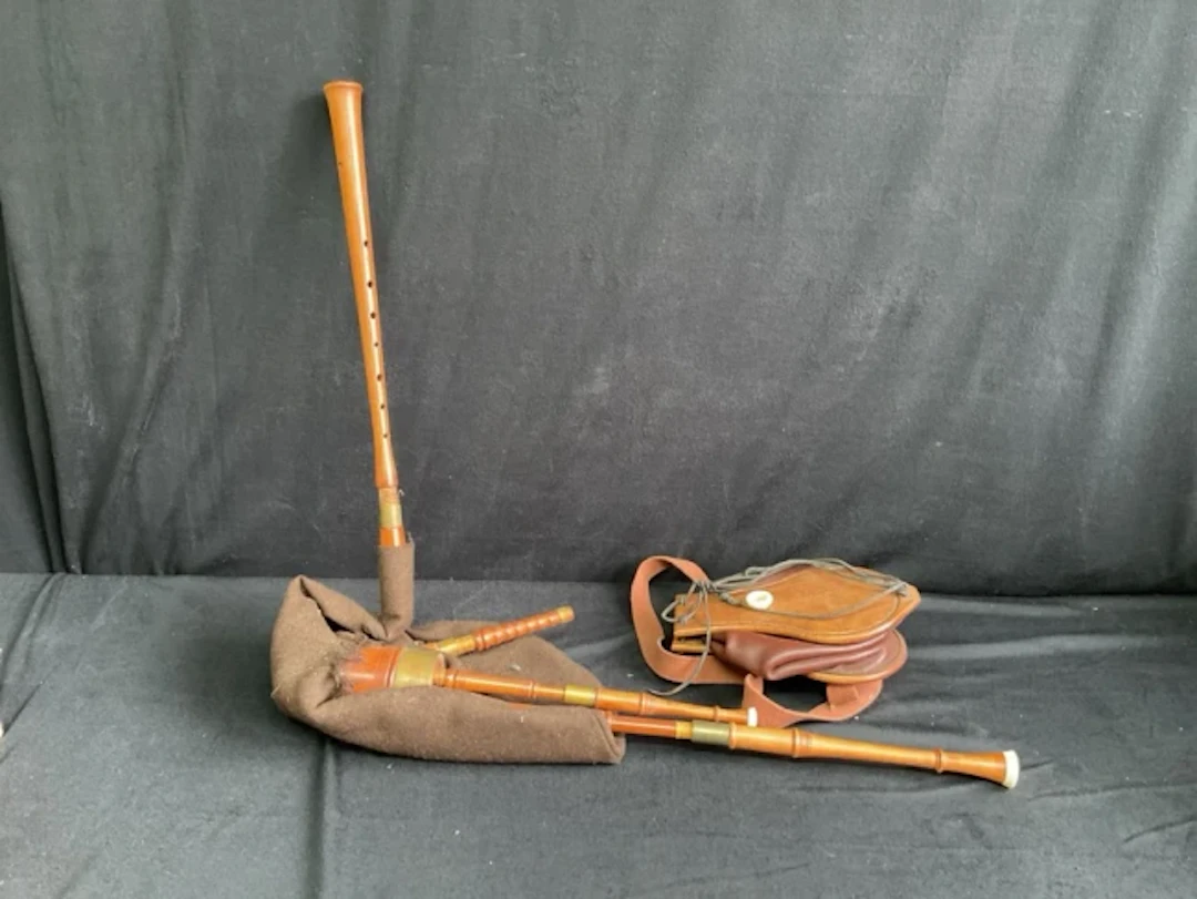 A set of holly Border bagpipes with three drones and open chanter