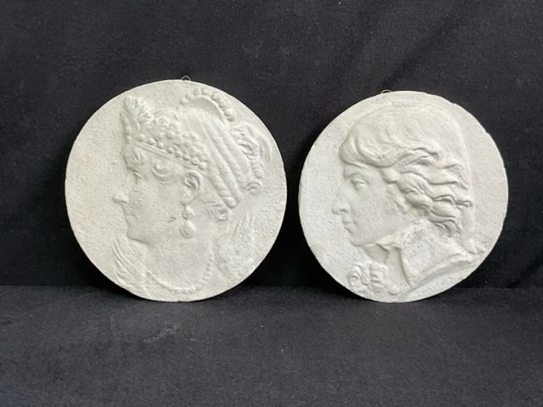A pair of circular plaster portrait medallions of Napoleon and Josephine