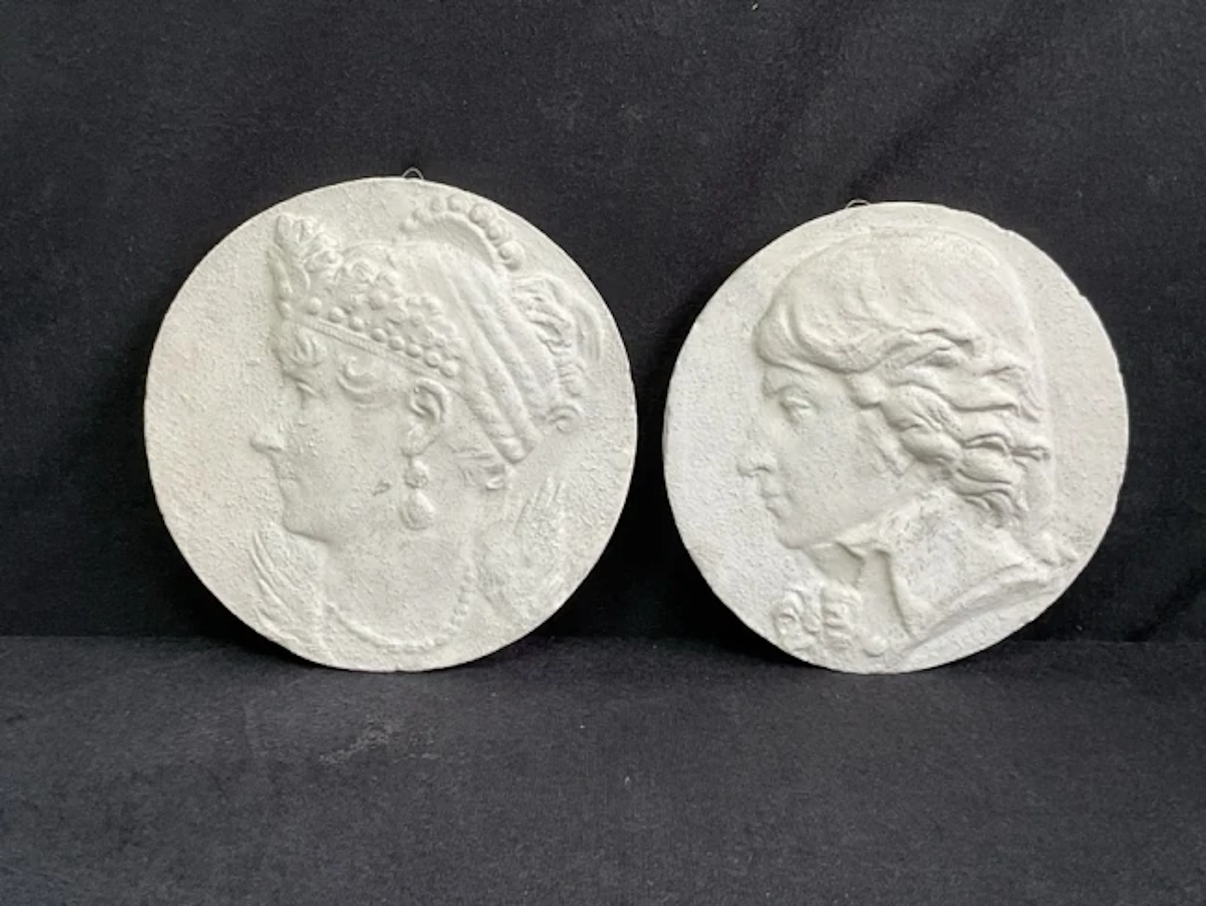 A pair of circular plaster portrait medallions of Napoleon and Josephine