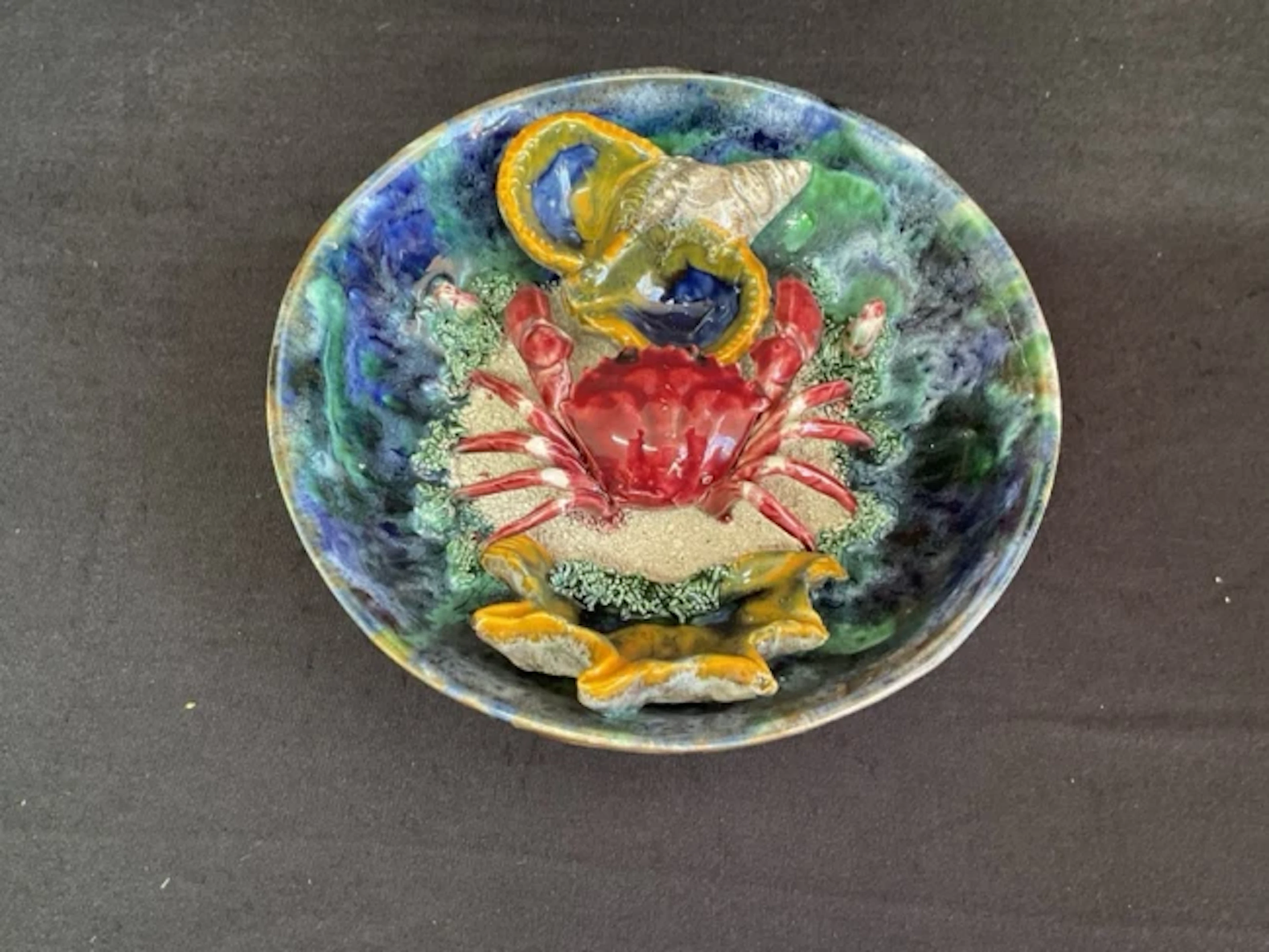 A C19th Portuguese Palissy style maioloca bowl containing a crab and