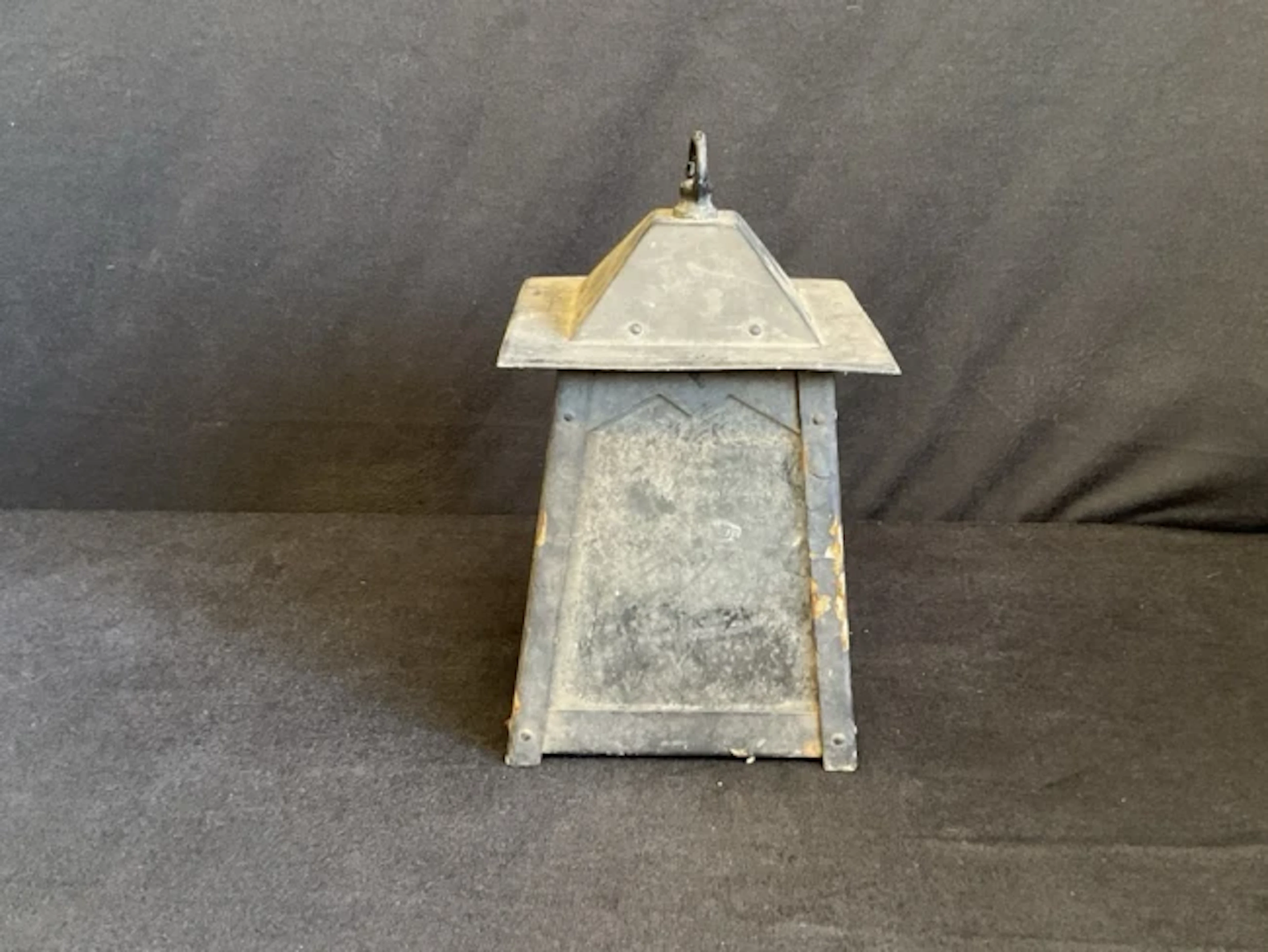 A brass arts & crafts style porch lantern with suspension hook on
