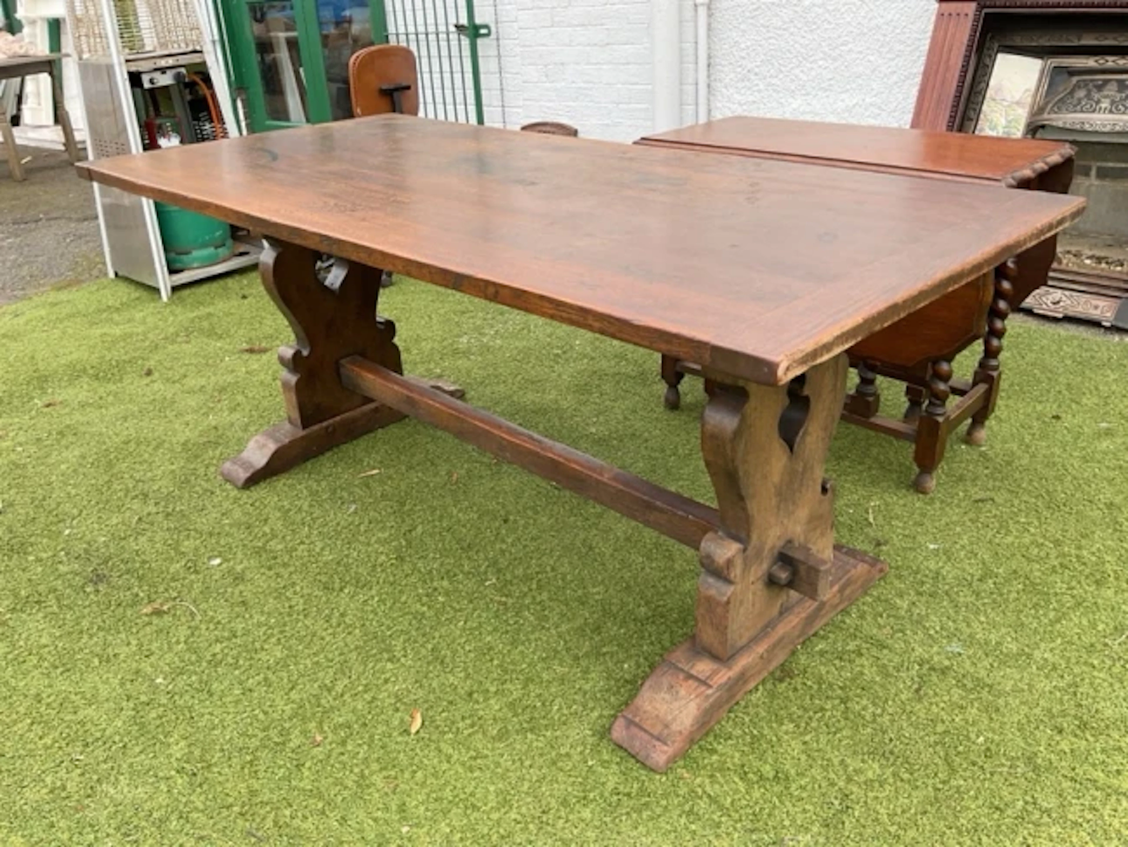 A 6ft oak refectory table with rectangular cleated top on pierced