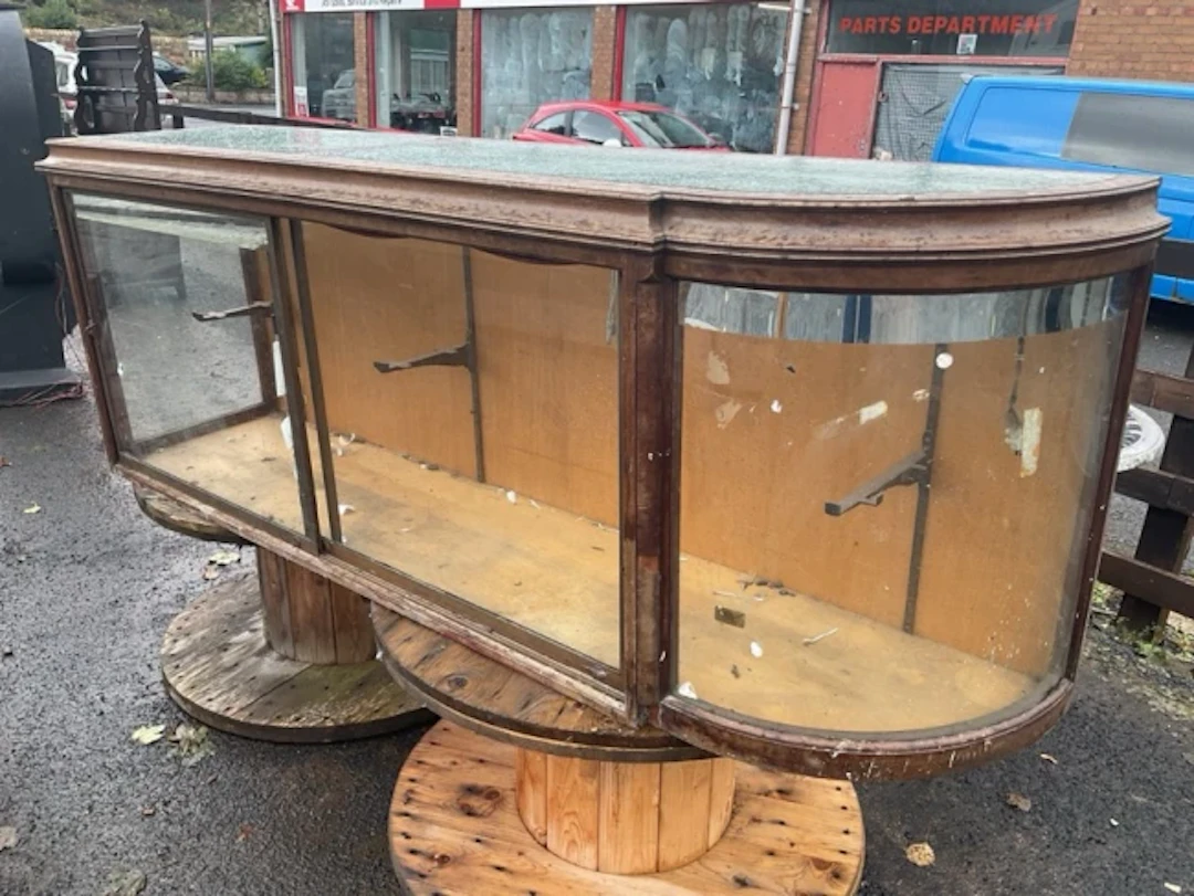 A haberdashery shop counter with concave moulded top having glass
