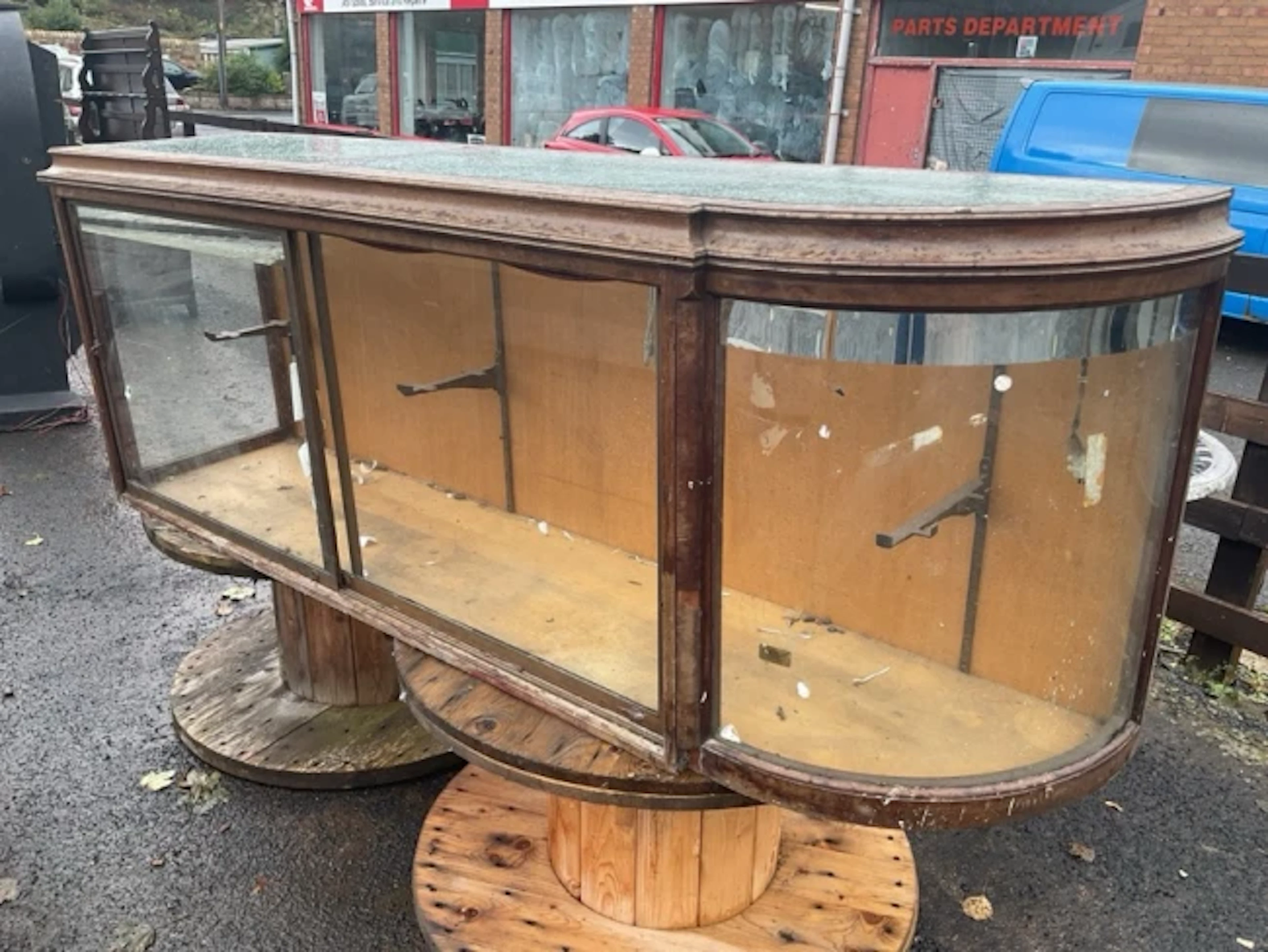 A haberdashery shop counter with concave moulded top having glass