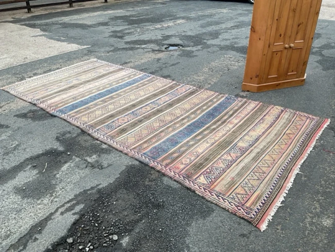 A Caucasian Soumak wool rug with striped pattern of stylised flowerheads