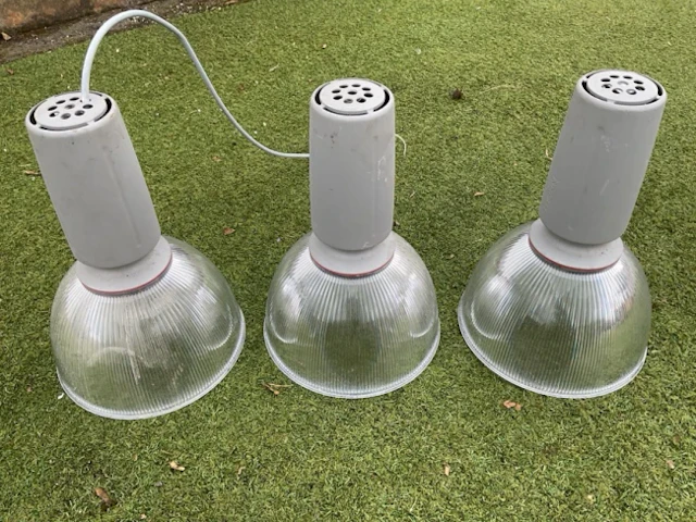 A set of three contemporary hanging lights with silvered ribbed bowl