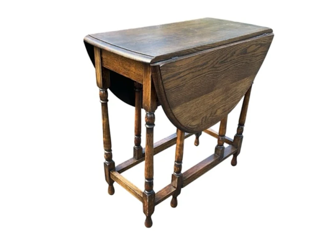 A Georgian style oak occasional table, the oval moulded top with two