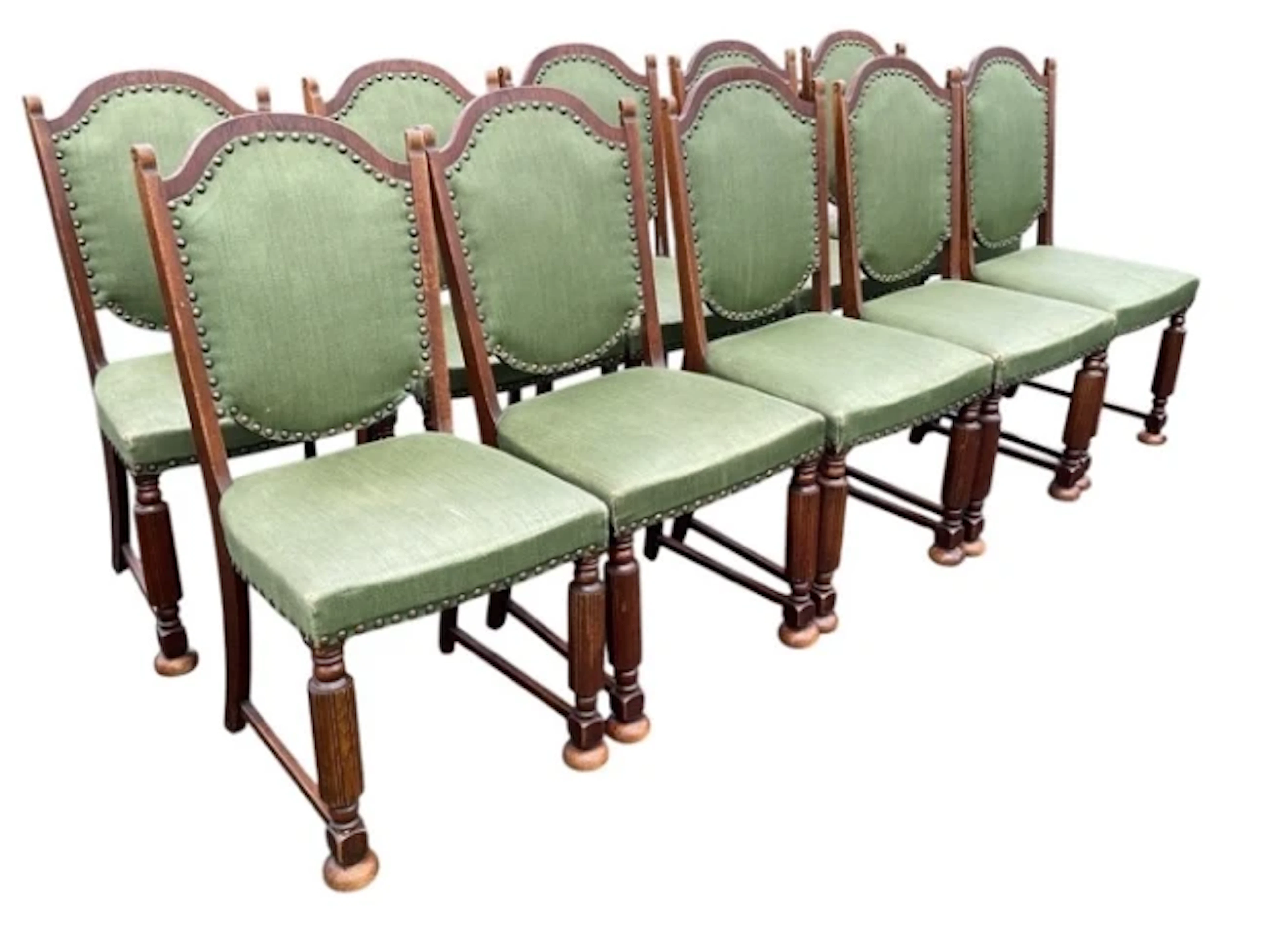 A set of ten Danish oak dining chairs with arched stud upholstered