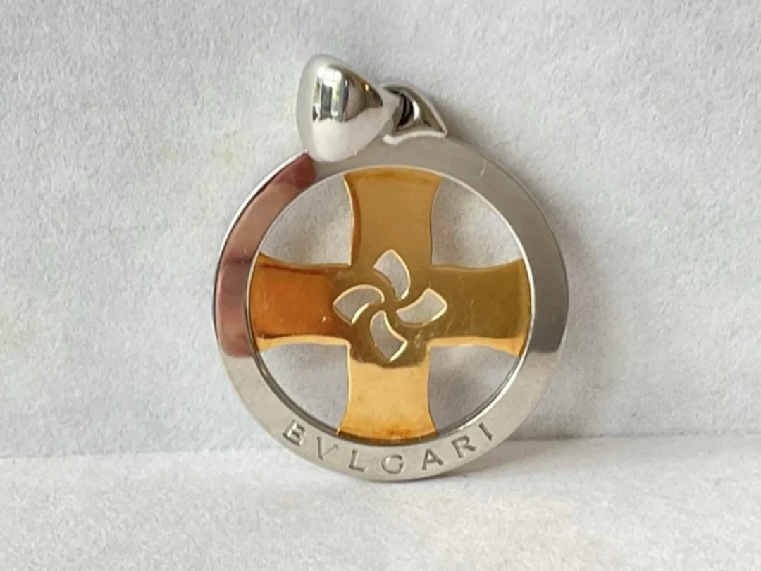 A Bvlgari stainless steel circular tondo pendant, having 18ct gold