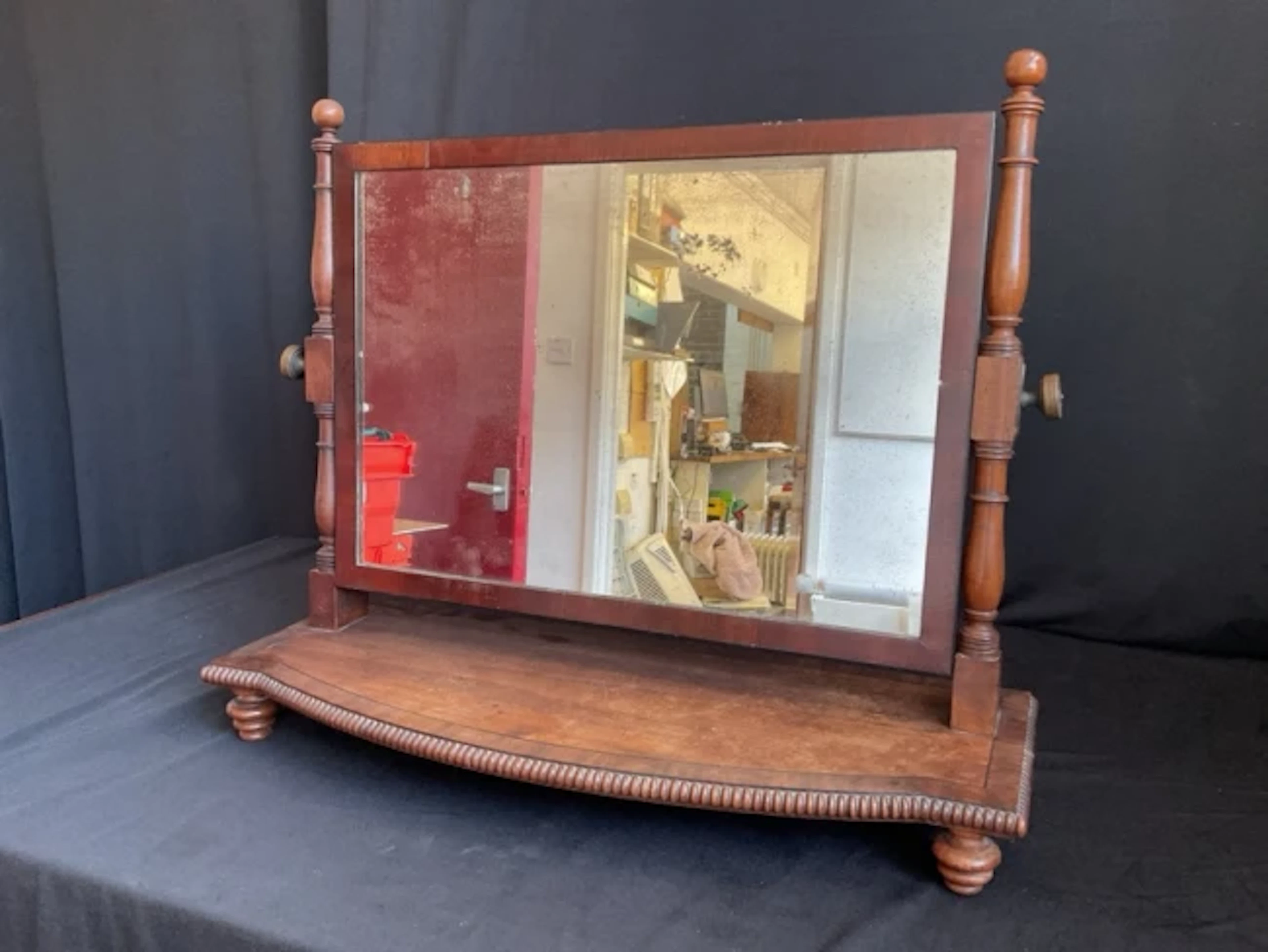 A George IV mahogany bowfronted dressing table mirror inlaid with