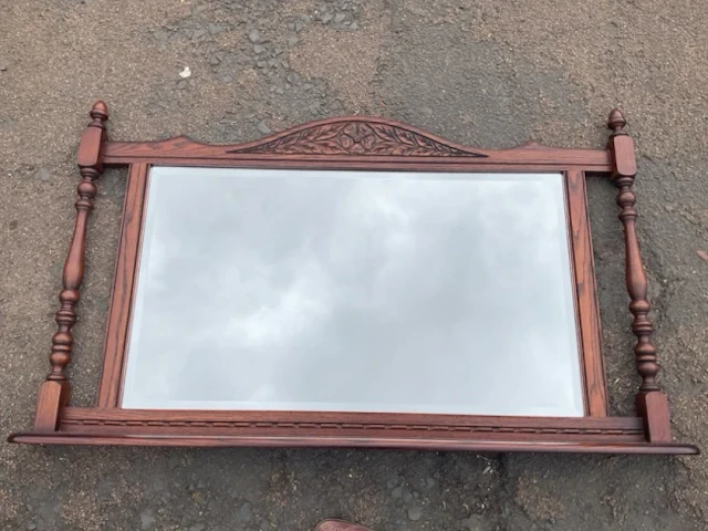 An Edwardian style oak overmantel mirror with arched flowerhead &