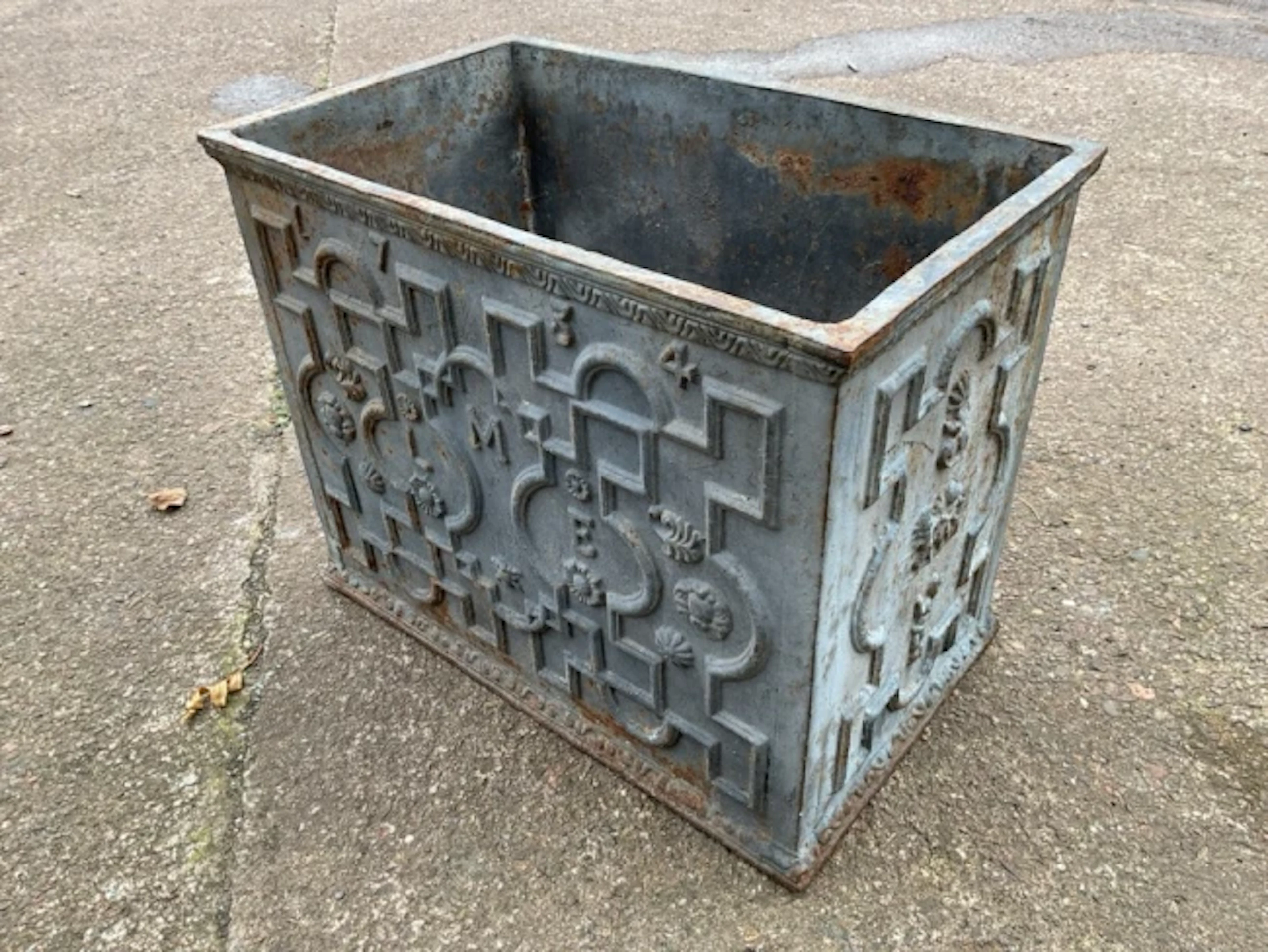 A lead style cast iron rectangular garden trough with decorative strapwork