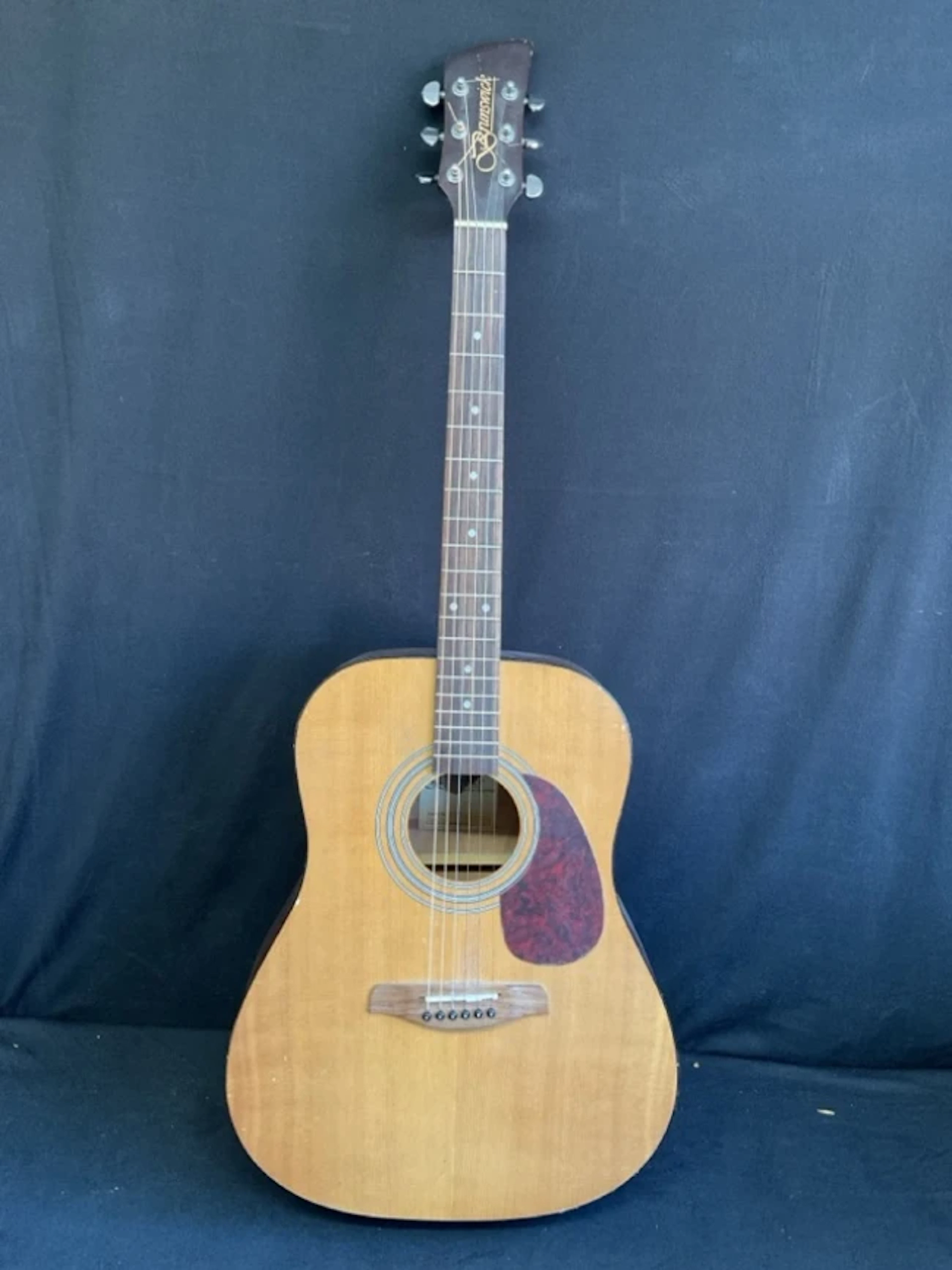 A Brunswick steel string acoustic guitar with cedar body, chromed