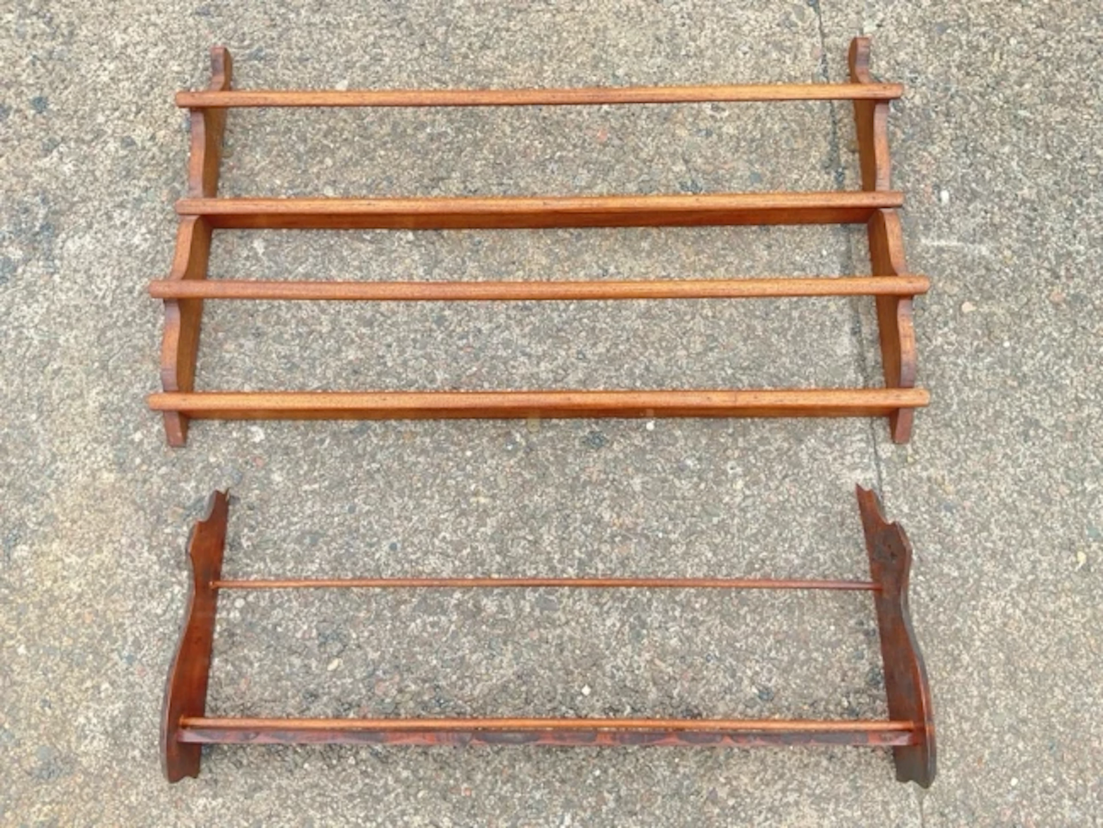 A wall plate rack having shaped ends and twin turned spindle plate
