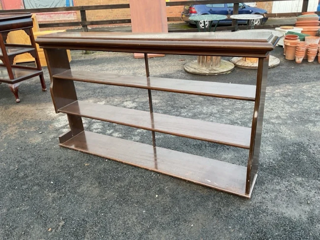A set of mahogany open shelves with moulded cornice above three wide
