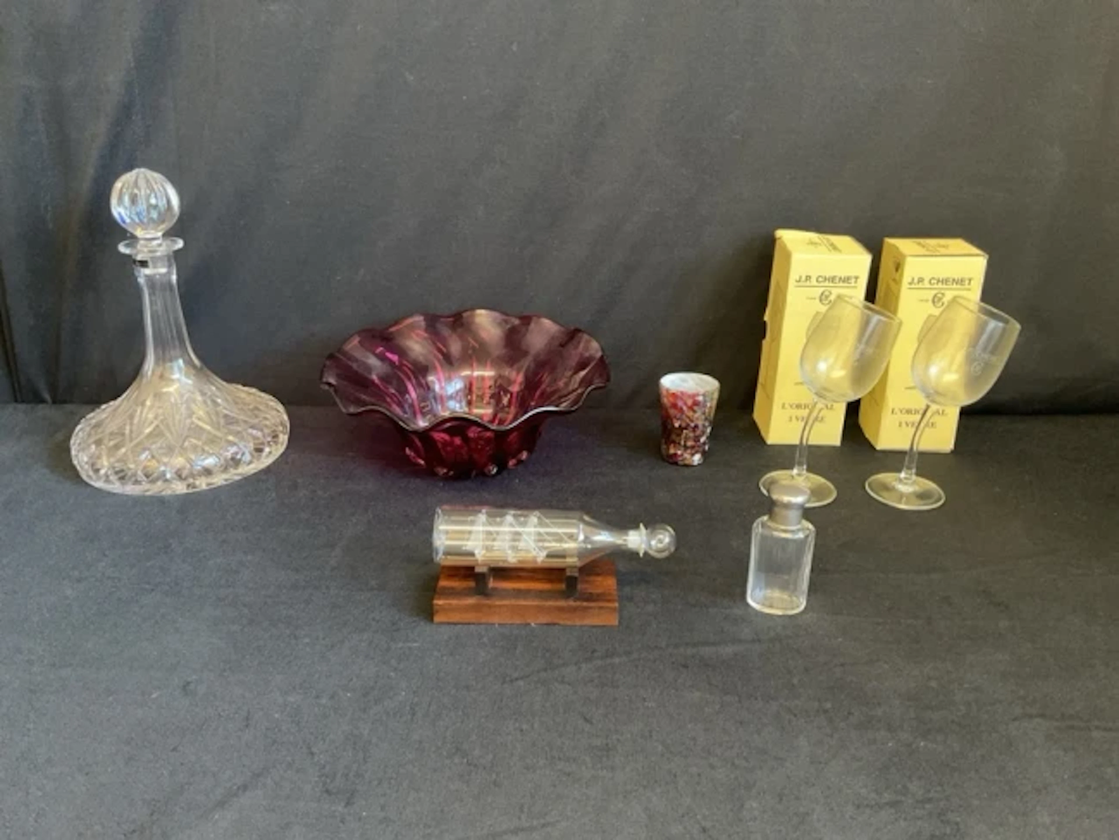 A Thomas Webb cut crystal ships decanter, a cranberry studio glass