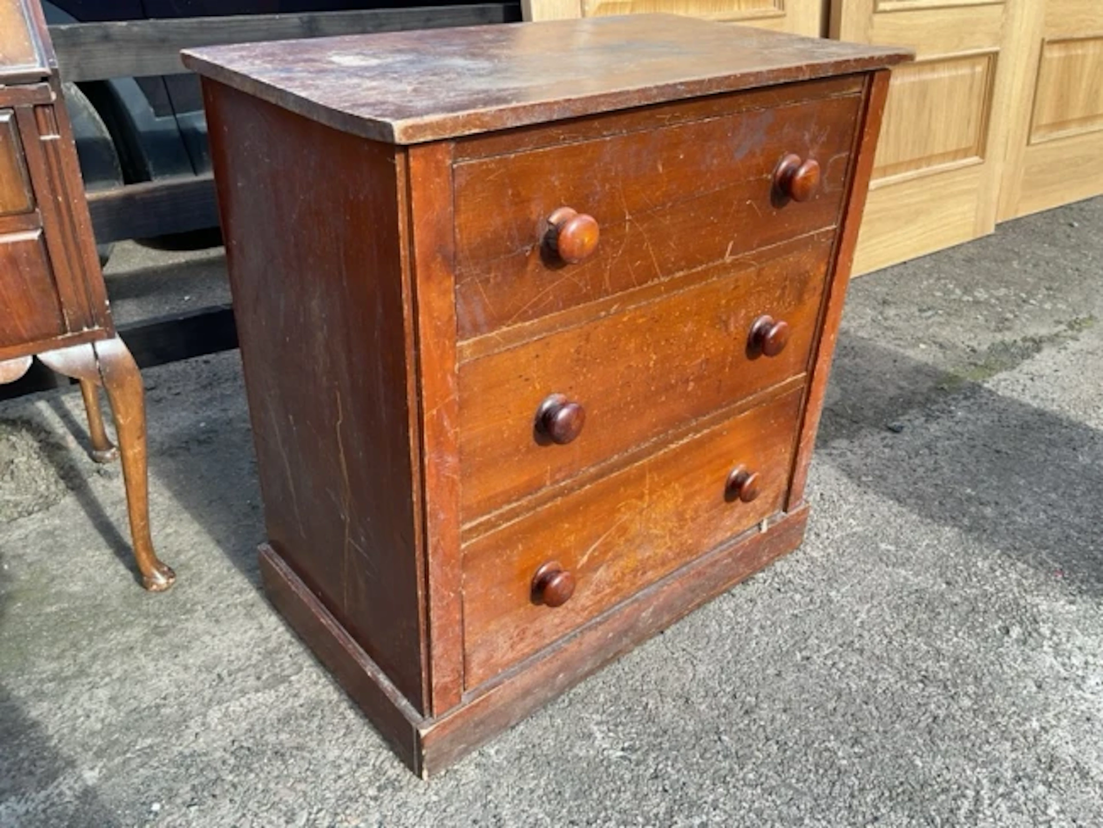 A Victorian mahogany chest with three long graduated knobbed drawers