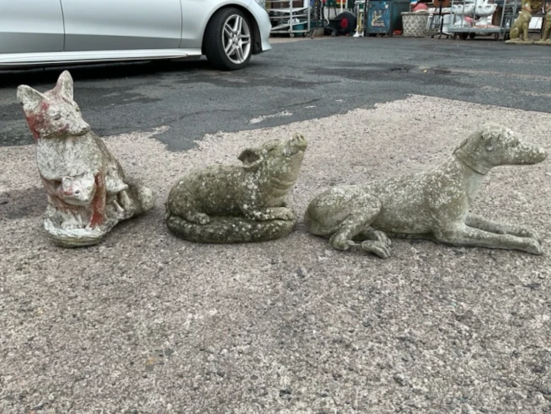 Three composition stone garden animal ornaments - a fox with cubs