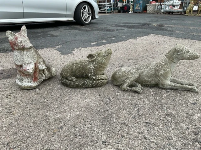 Three composition stone garden animal ornaments - a fox with cubs