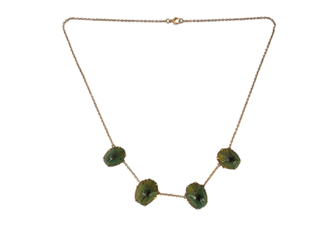 An antique unmarked gold scarab shell necklace, the four casings claw