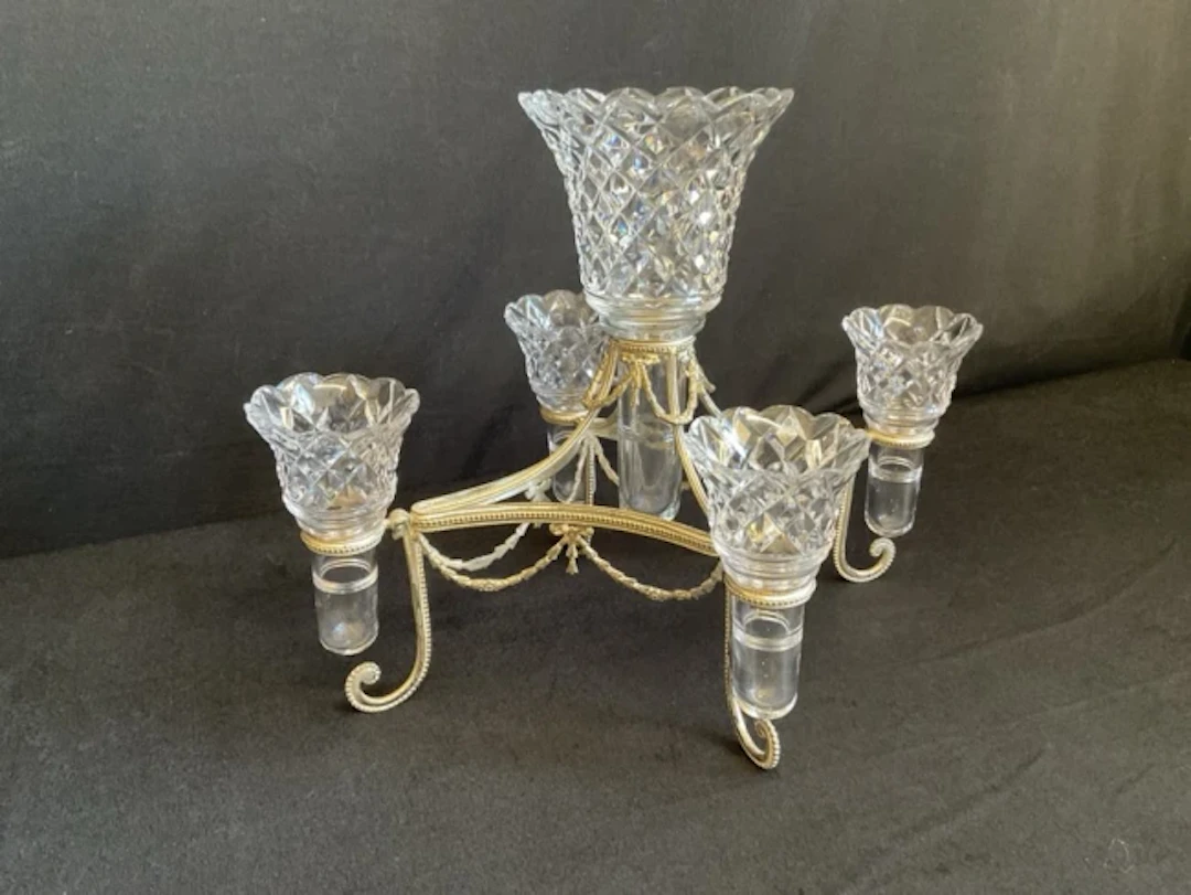 An Edwardian silver plated and cut glass épergne, the concave lozenge