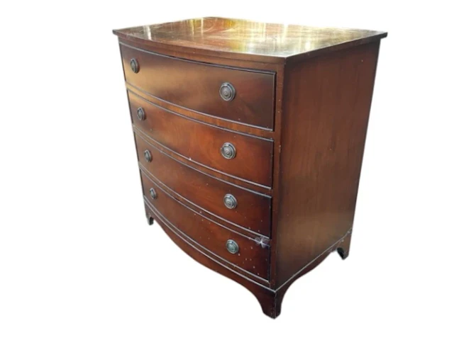 A bowfronted mahogany chest of four long drawers mounted with brass