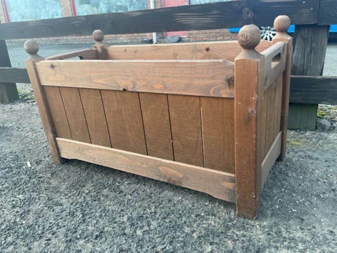 A rectangular pine plant trough with plastic liner, the panelled boarded