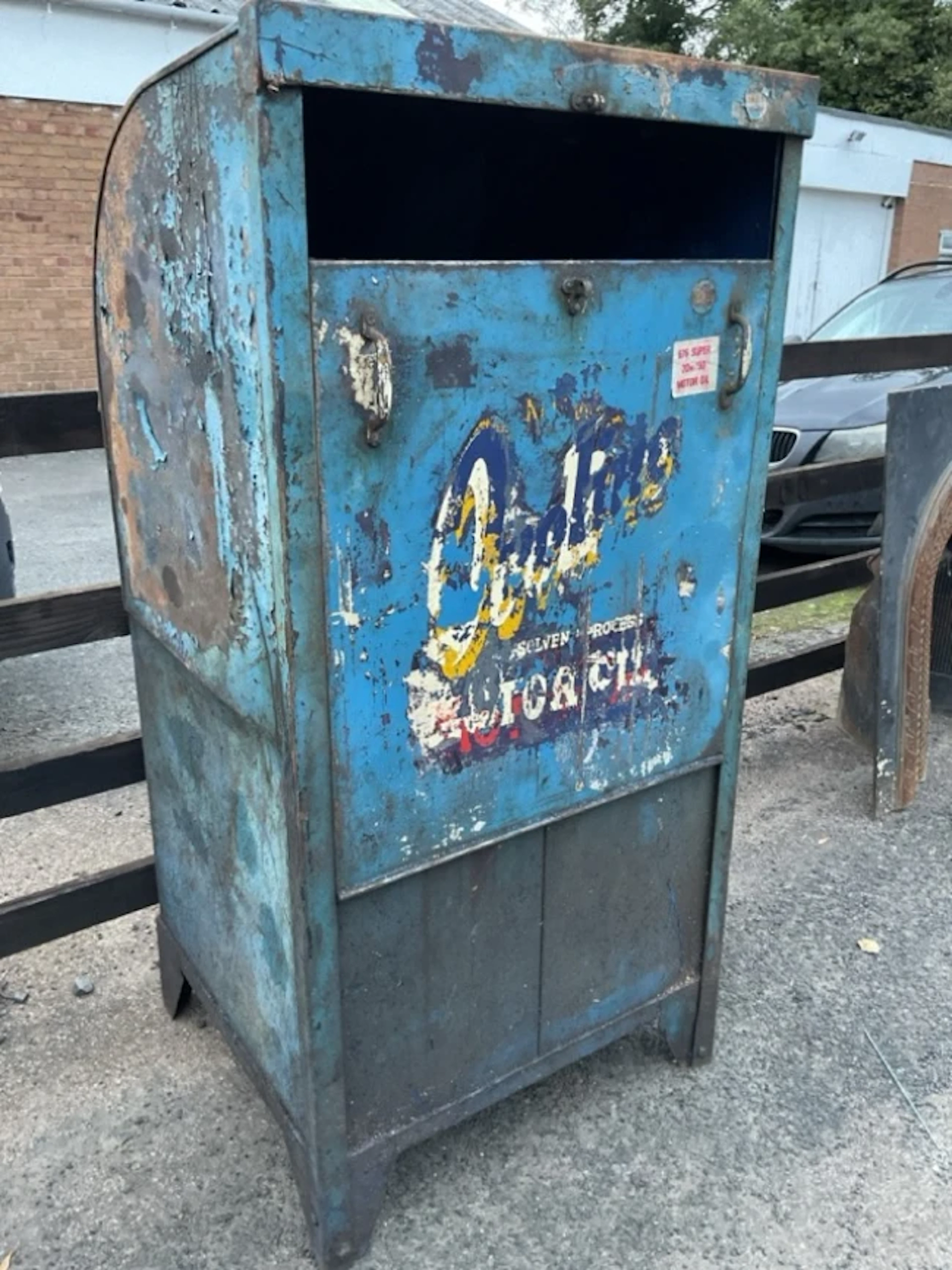 A 50s Ovaline Motor Oil dispensing cabinet of rounded shape having