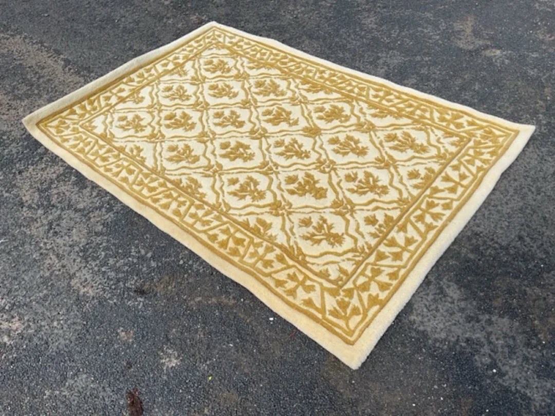 A thick pile Tai Ping wool rug woven with lemon latticework field