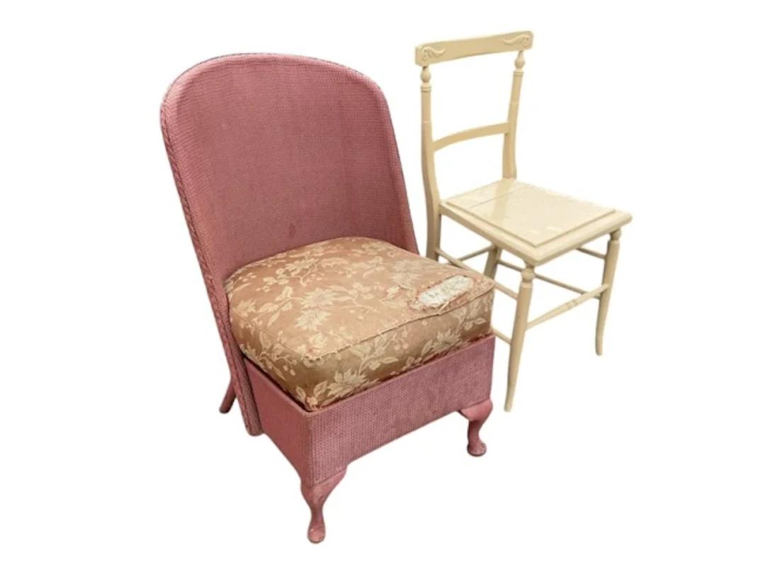 A Lloyd Loom style chair with arched back above a cushion seat, raised
