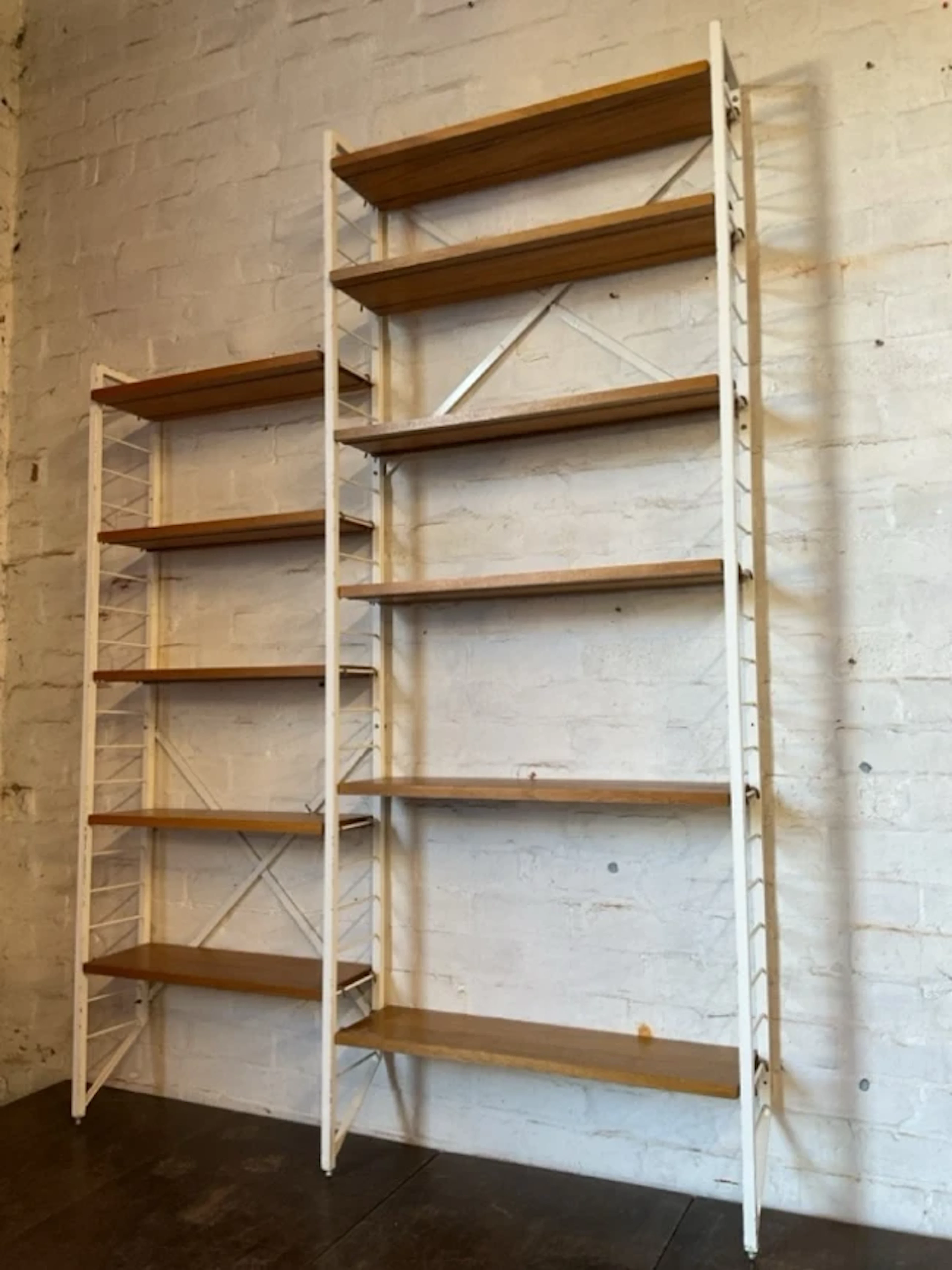 A painted Ladder-Rack unit with two sections of adjustable rectangular