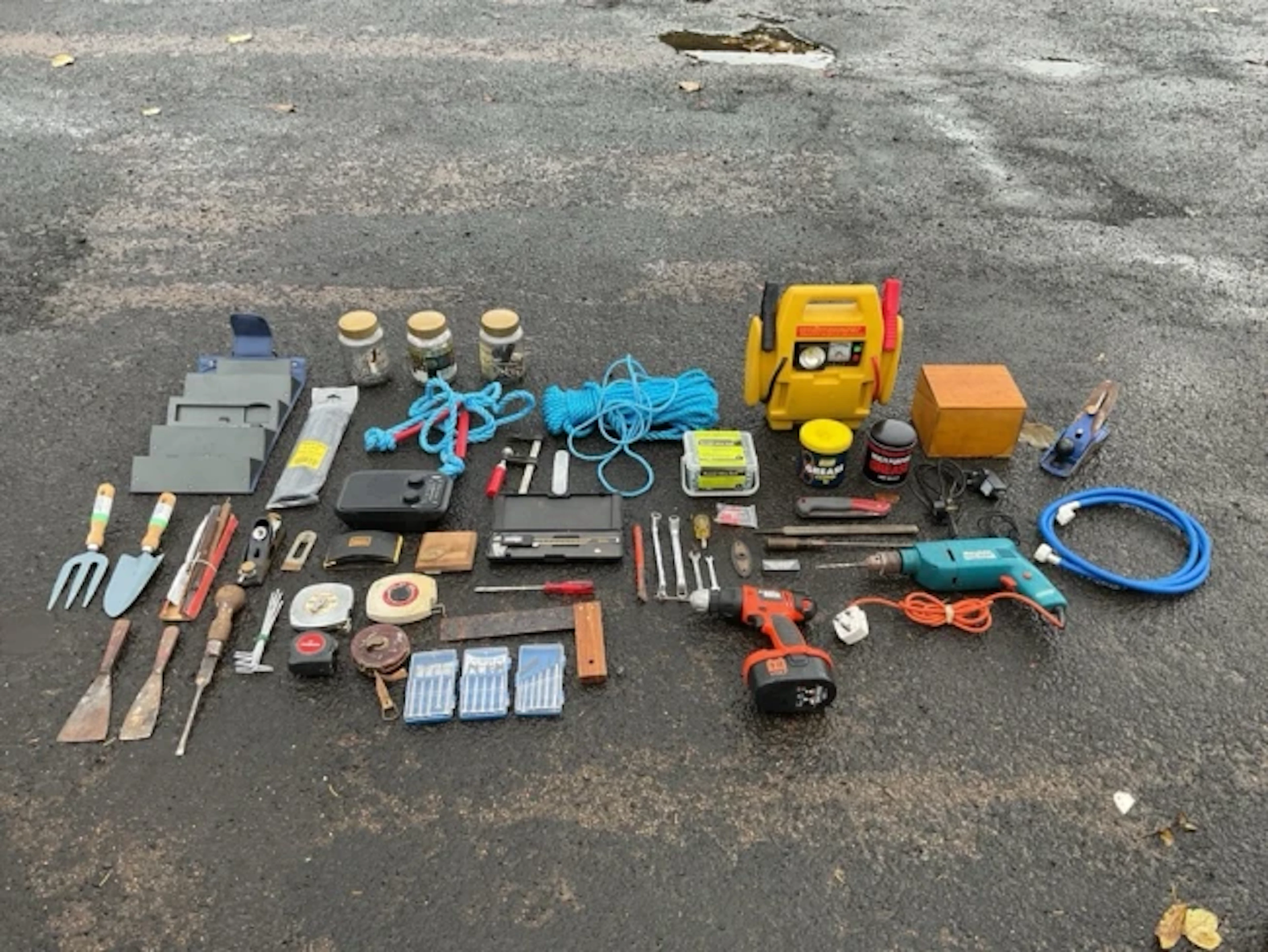A large collection of miscellaneous tools including portable jump