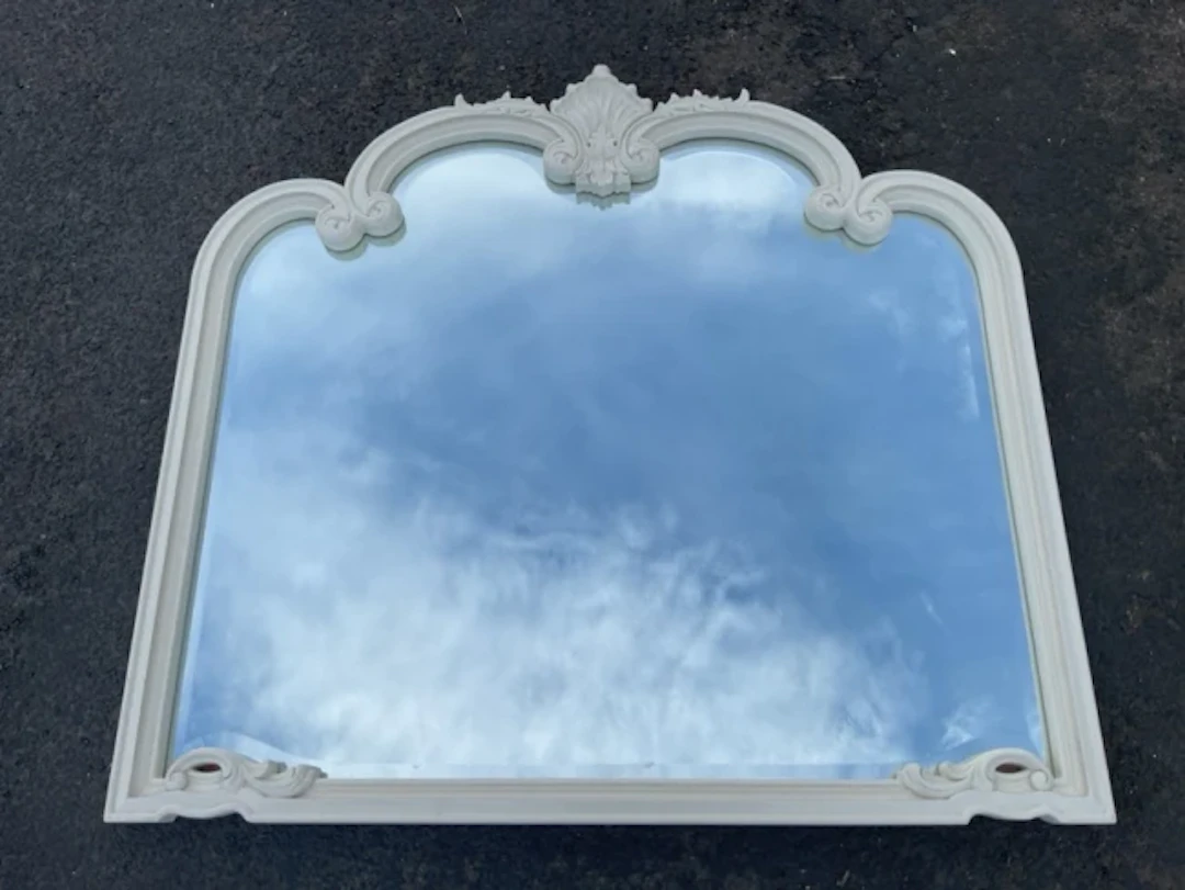 A contemporary Victorian style overmantle mirror with bevelled plate
