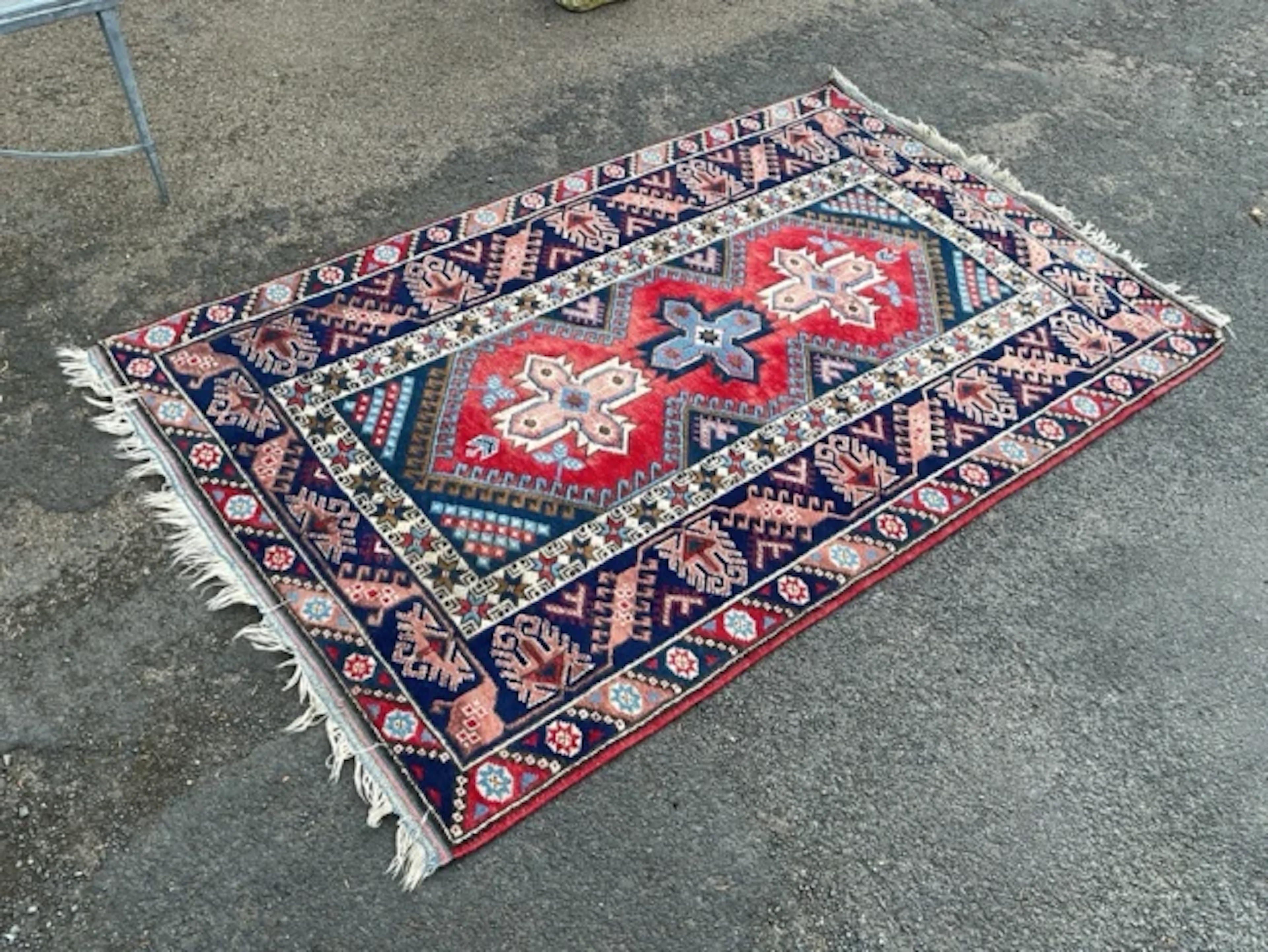 A Turkish Oushak wool rug with three cruciform medallions and hooked