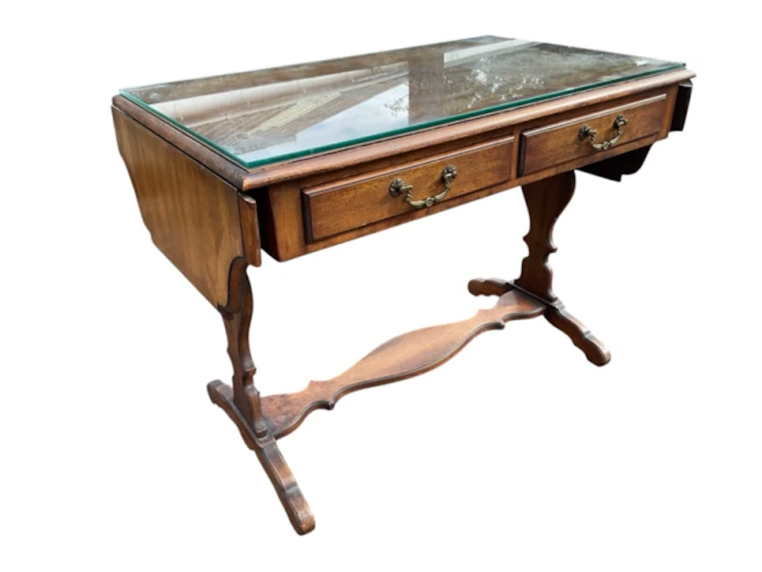 A coffee table modelled as a miniature sofa table with plate glass