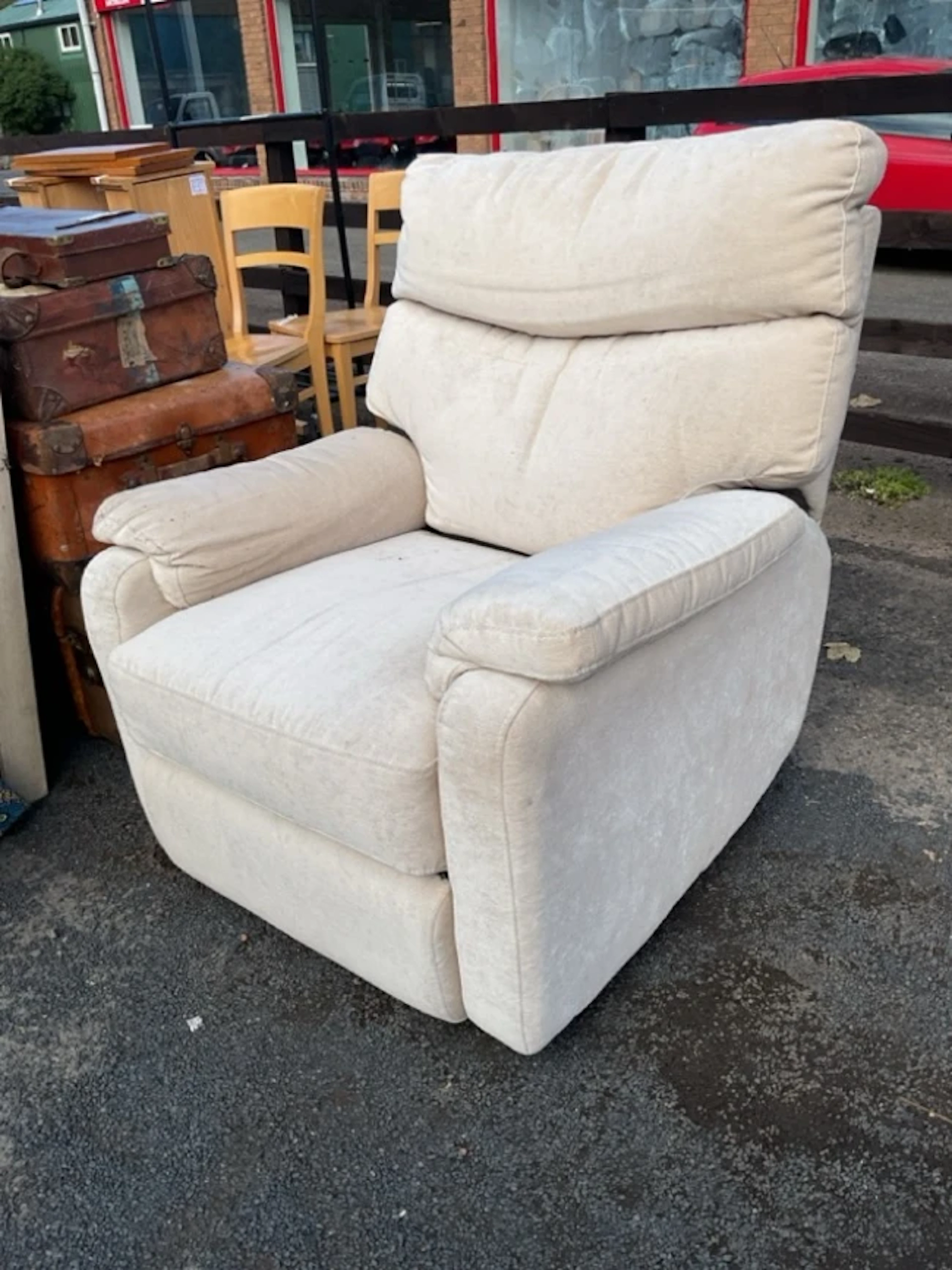 A contemporary reclining armchair with integral footstool, the cushion
