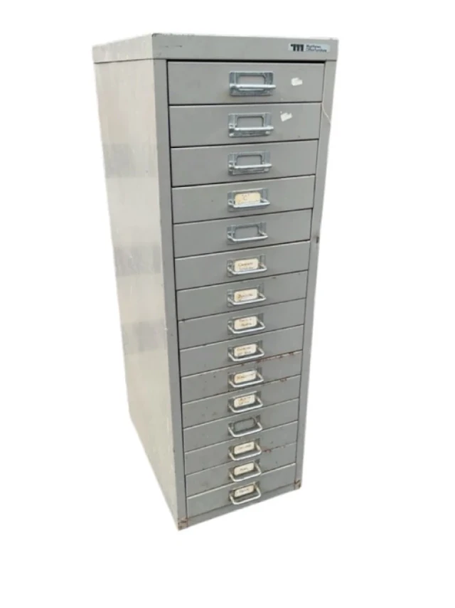A metal cabinet of fifteen small drawers with chromed tubular label