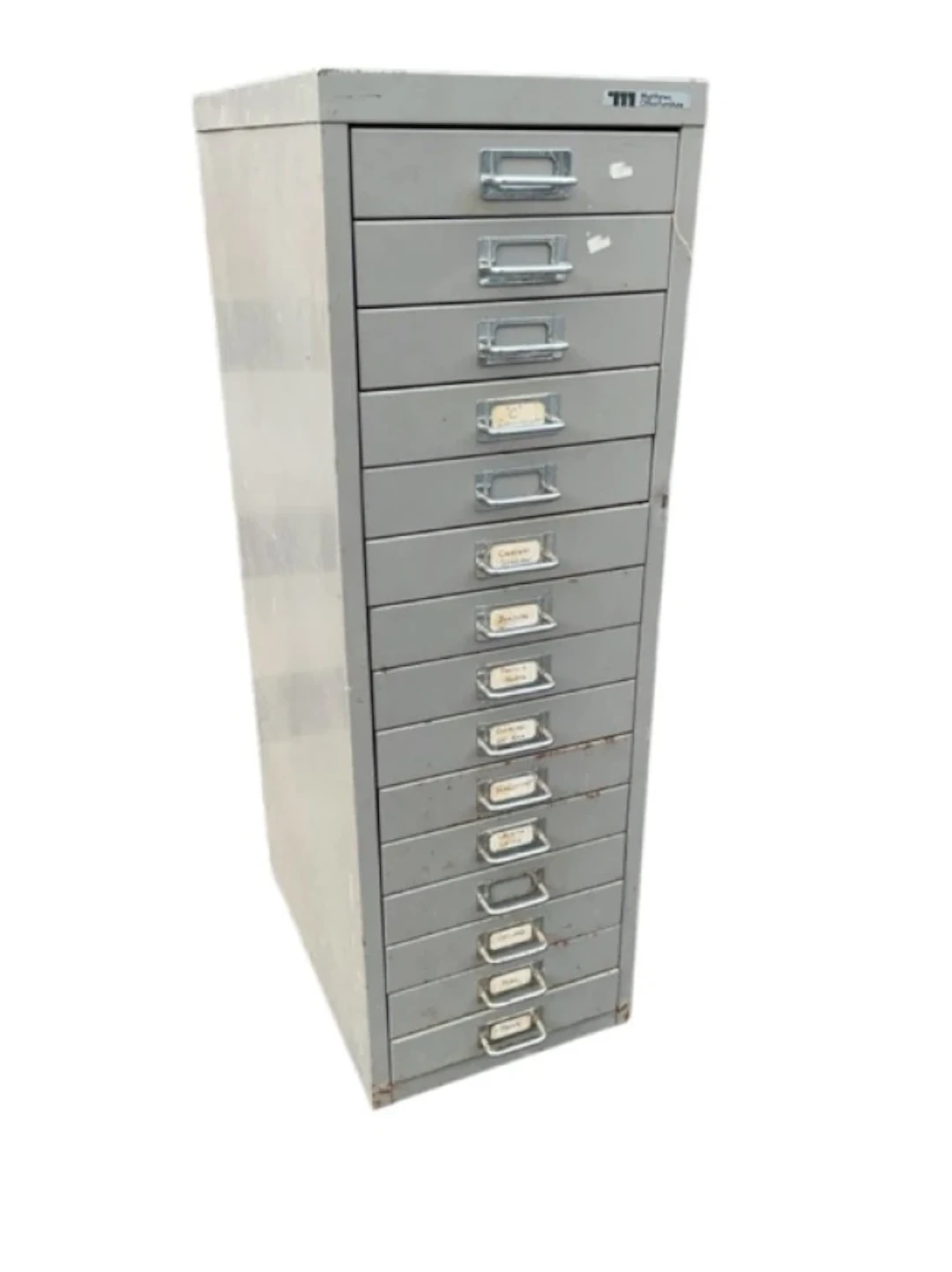 A metal cabinet of fifteen small drawers with chromed tubular label