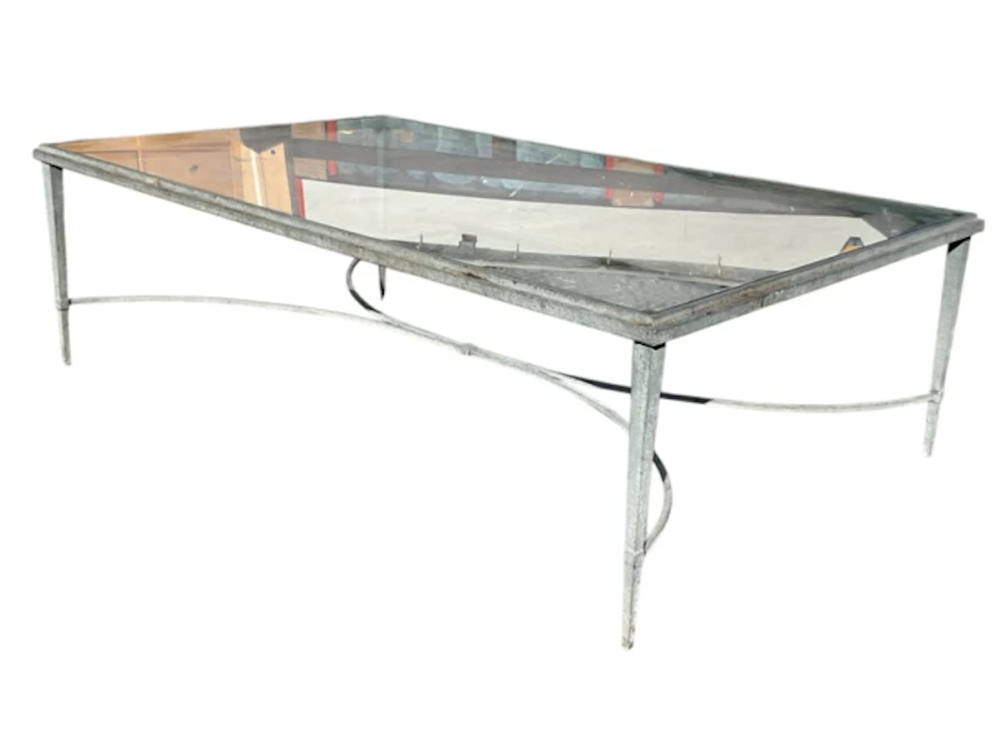 A contemporary plate-glass topped rectangular coffee table on patinated