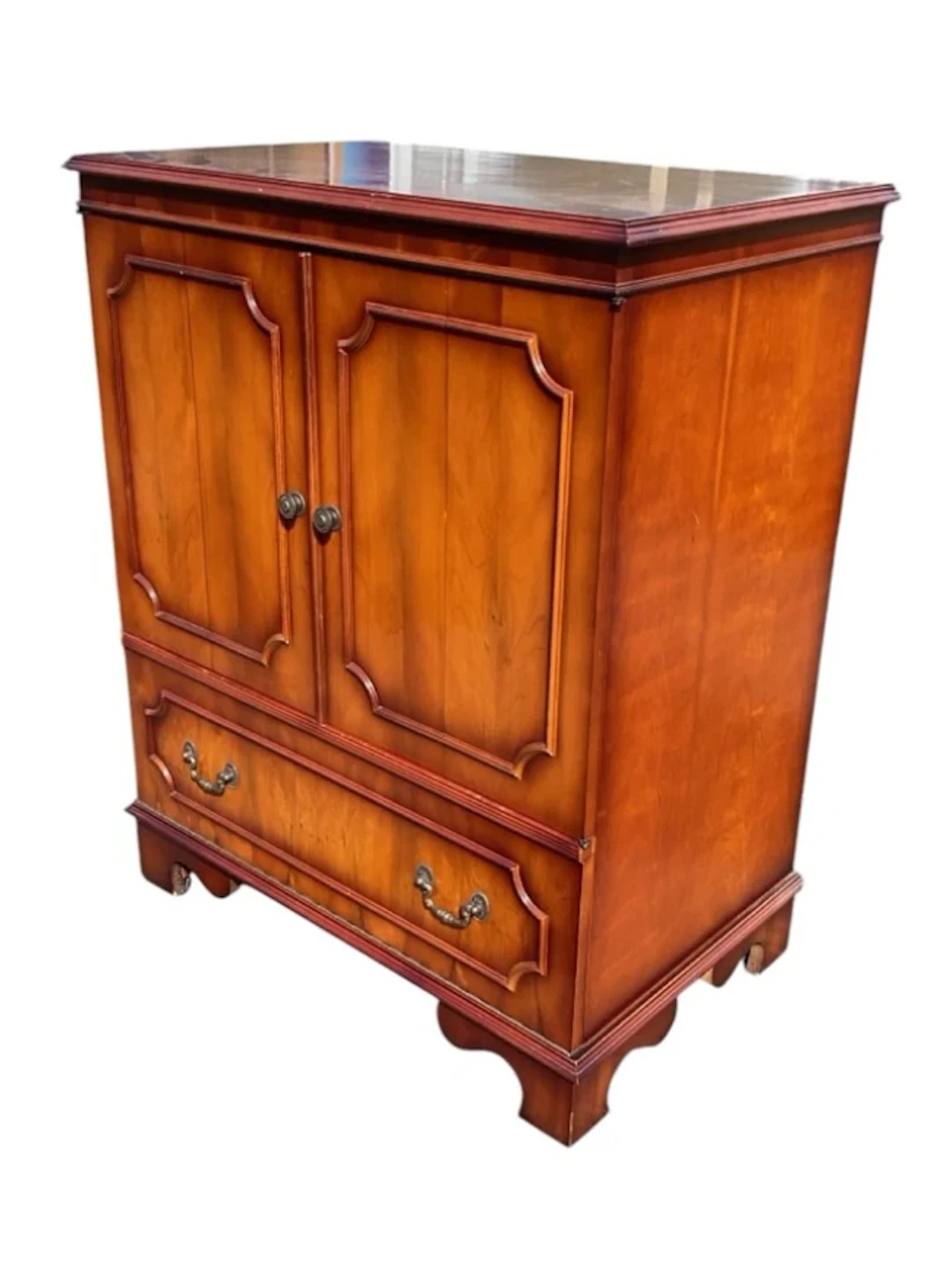 A contemporary yew cabinet with moulded rectangular top above hinged