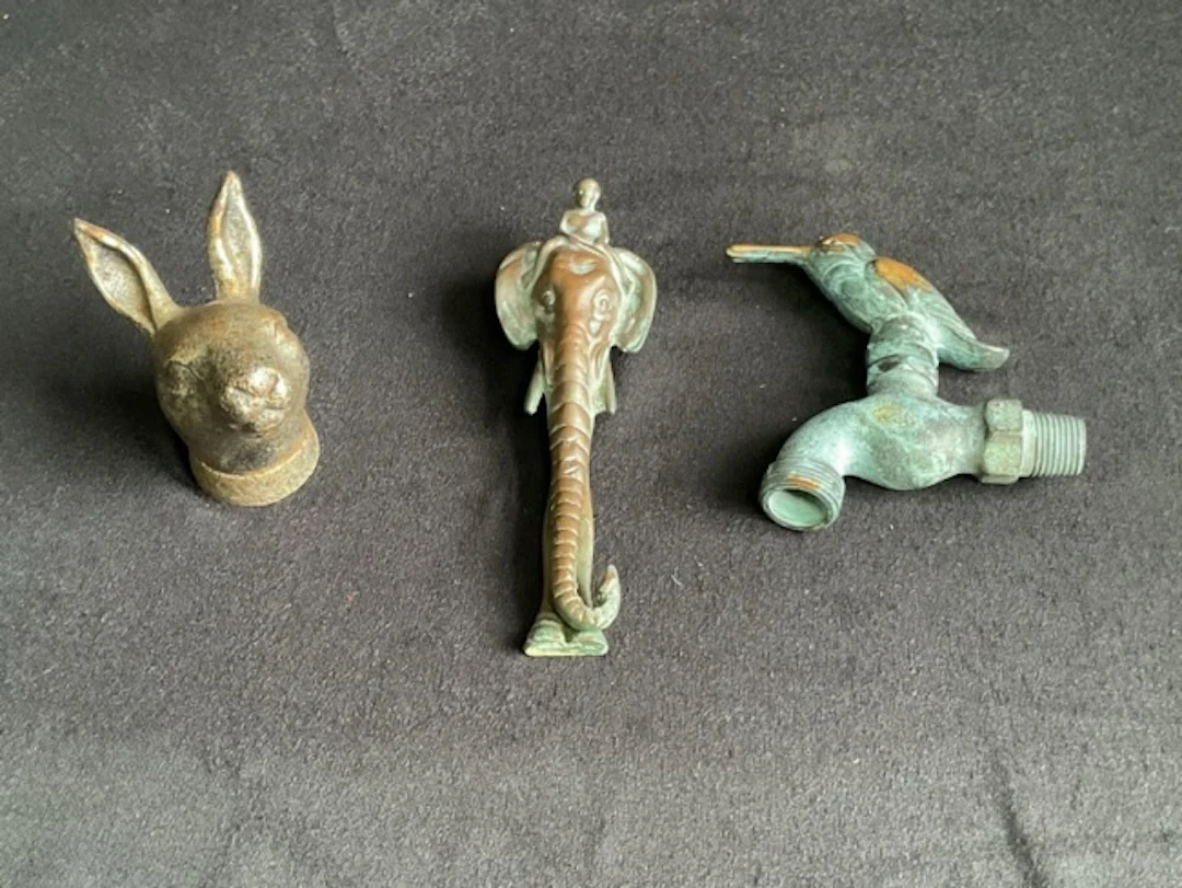 A heavy cast iron hares head door knocker; another brass in the form