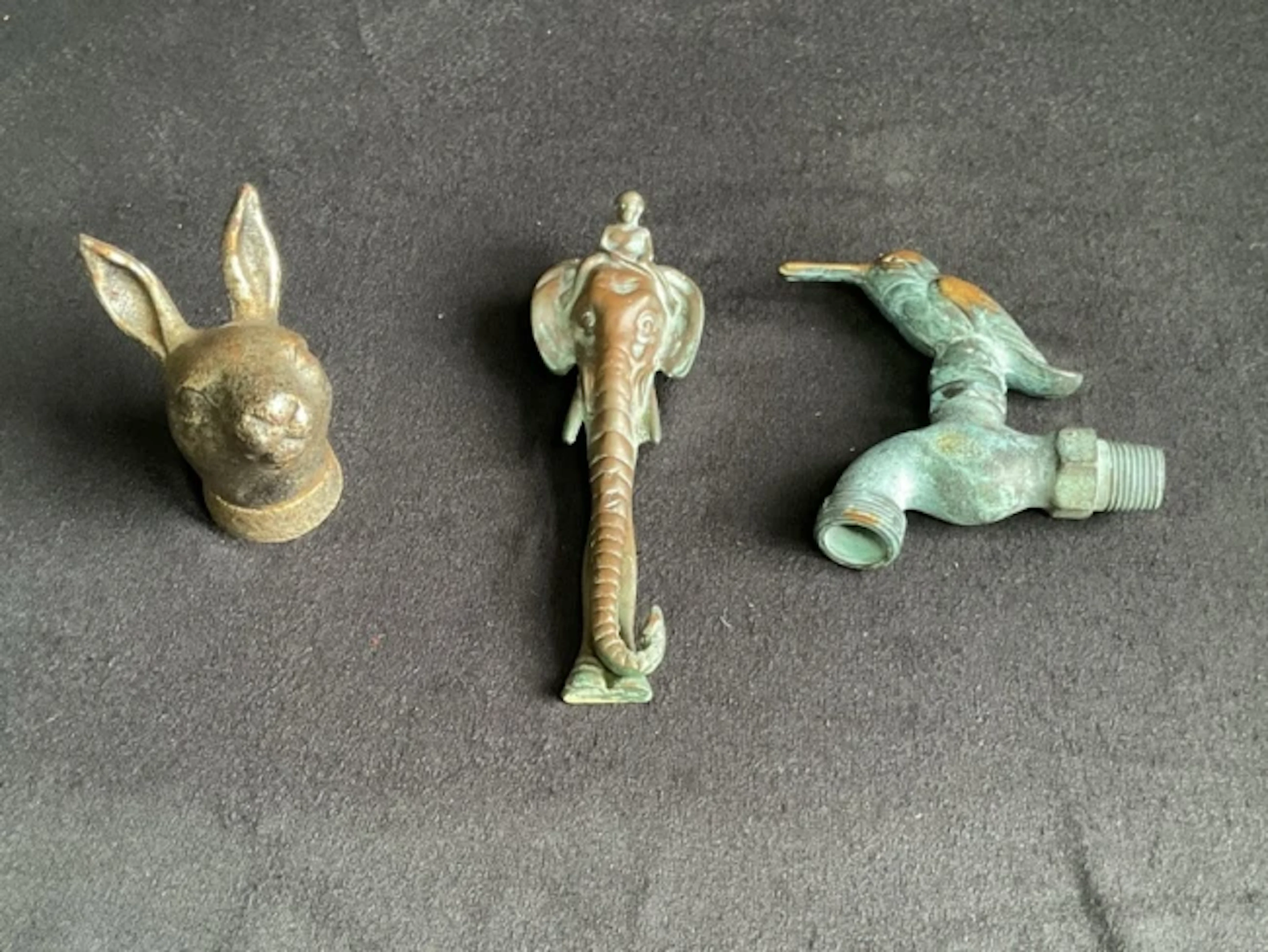 A heavy cast iron hares head door knocker; another brass in the form