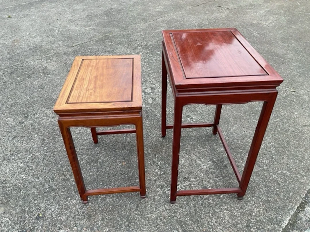 Two Chinese hardwood nesting tables with rectangular panelled tops
