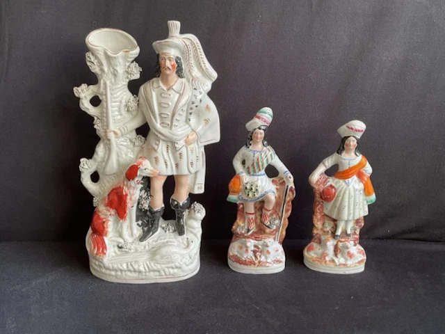 A Victorian Staffordshire flatback spill vase of a huntsman beside