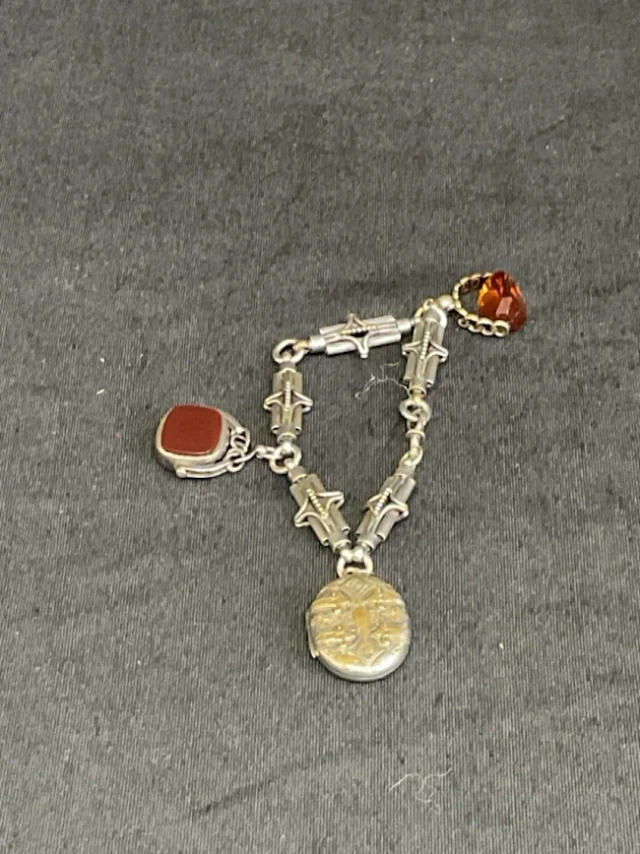 A Victorian silver plated fancy link bracelet suspending a plated